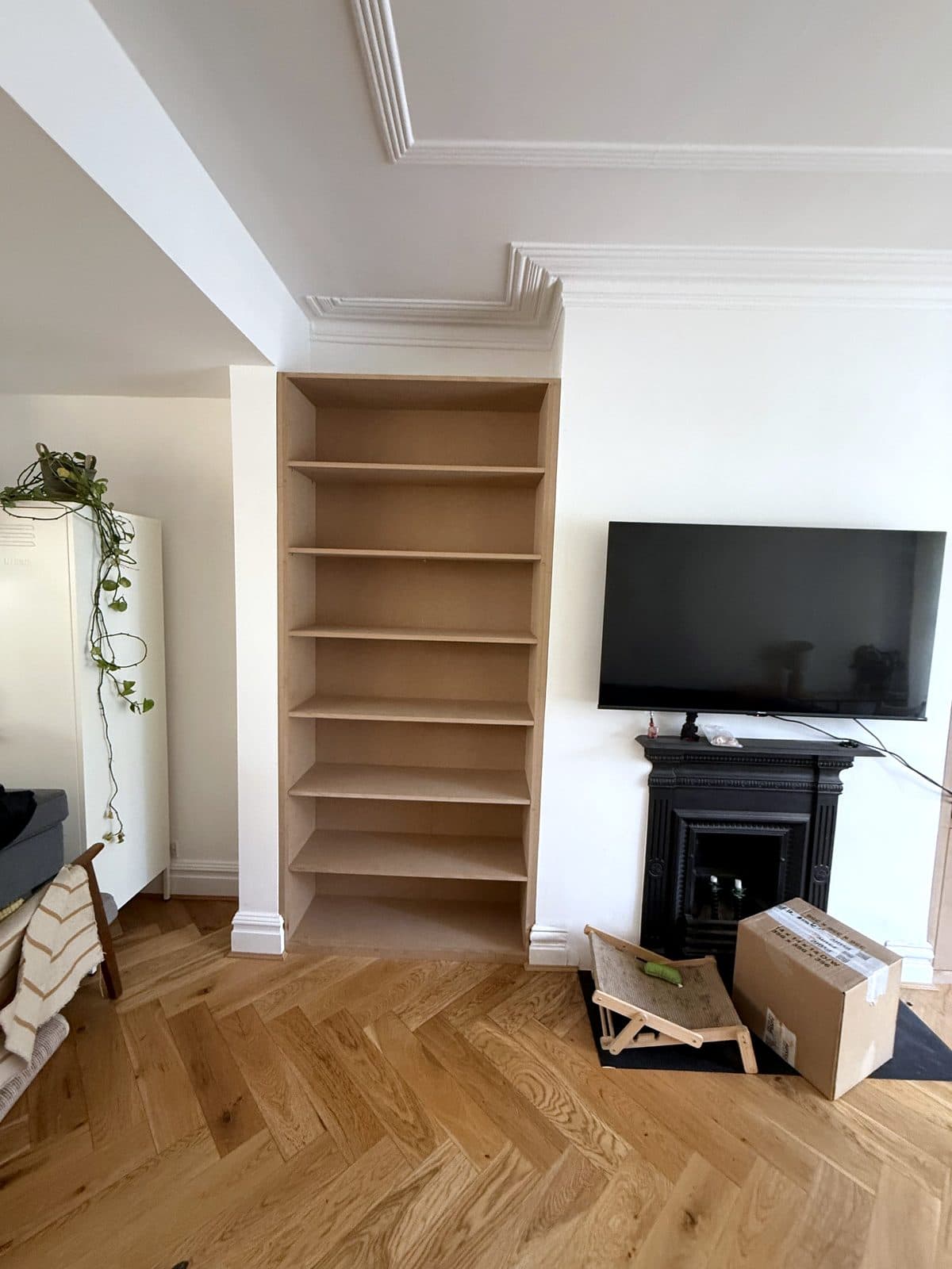 Full-height shelving beside the fireplace