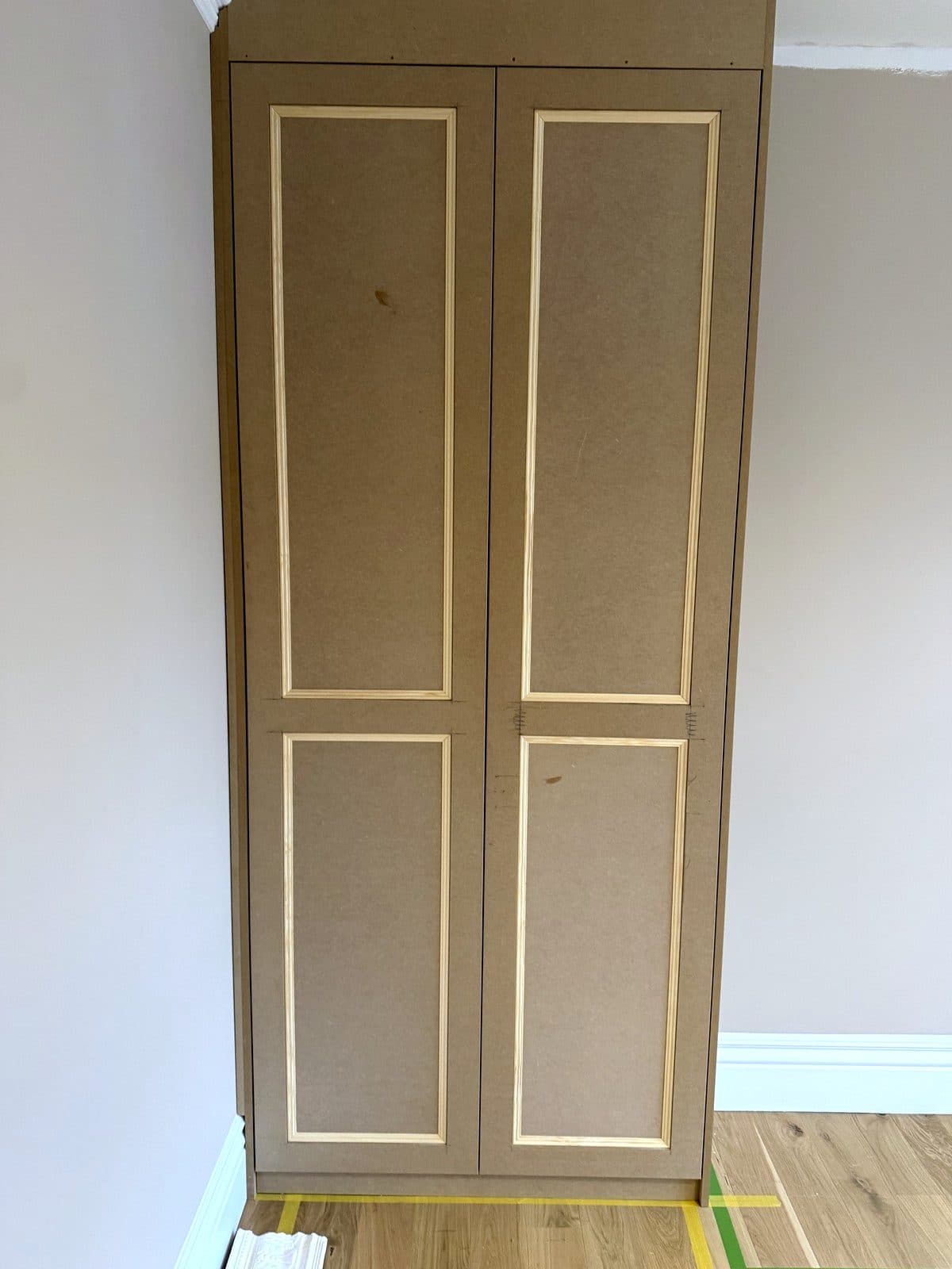 Left wardrobe with two panelled doors, floor to ceiling