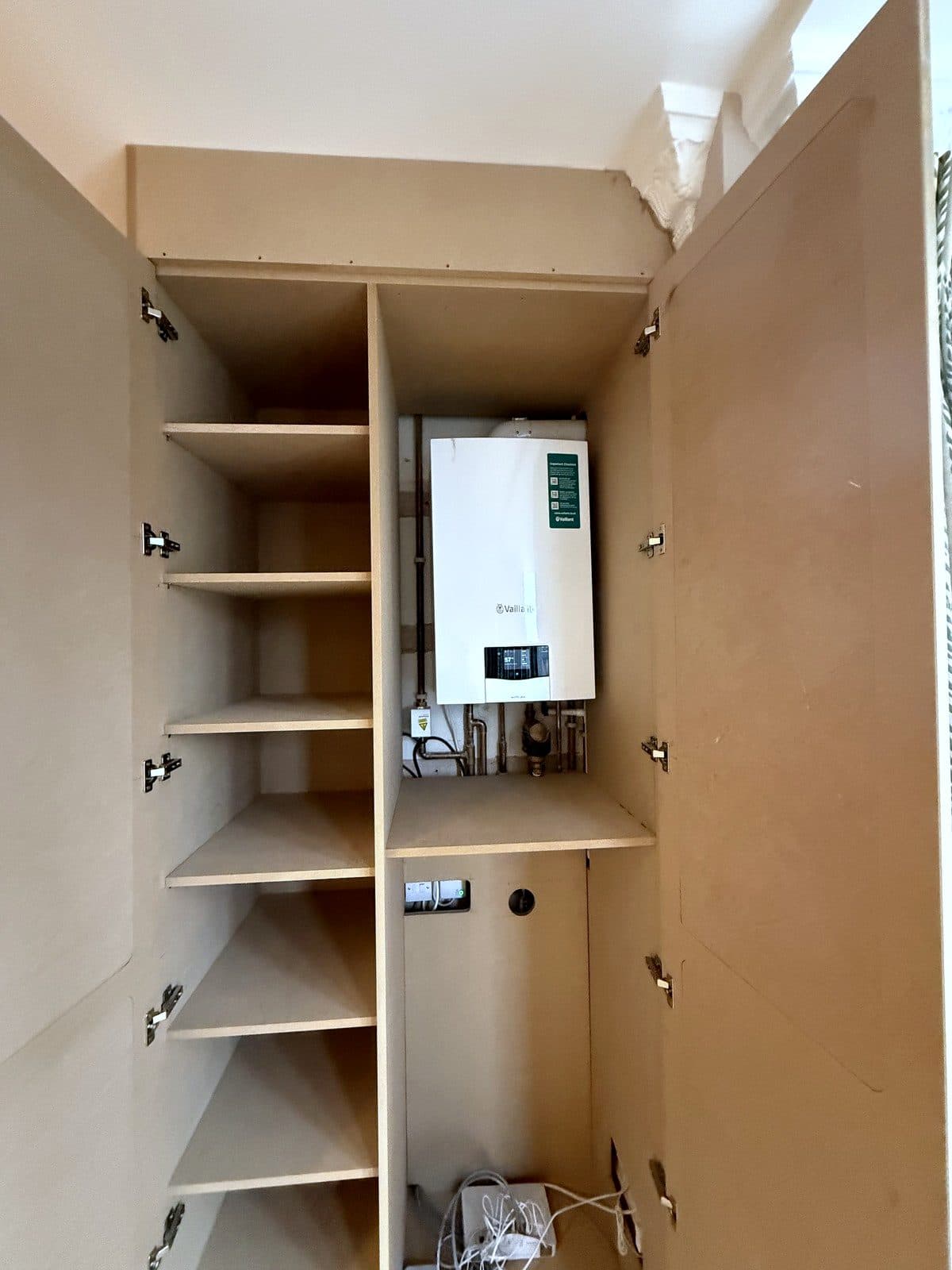 Inside the boiler side, with the controls and pipes reachable
