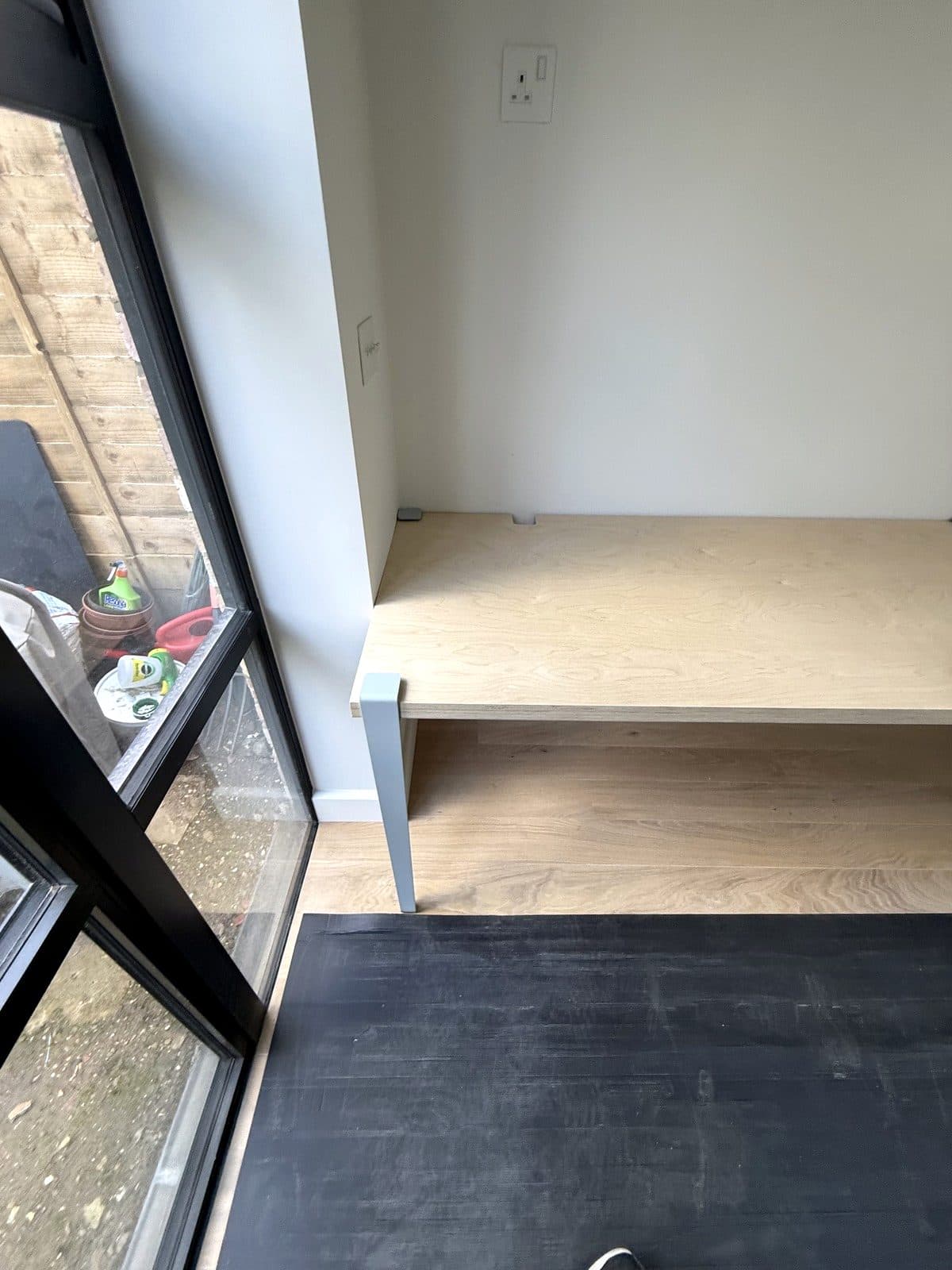 Desk and shelf beside the glazed doors
