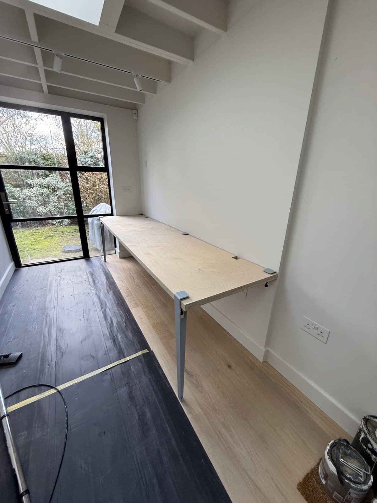 Desk on its steel legs by the window