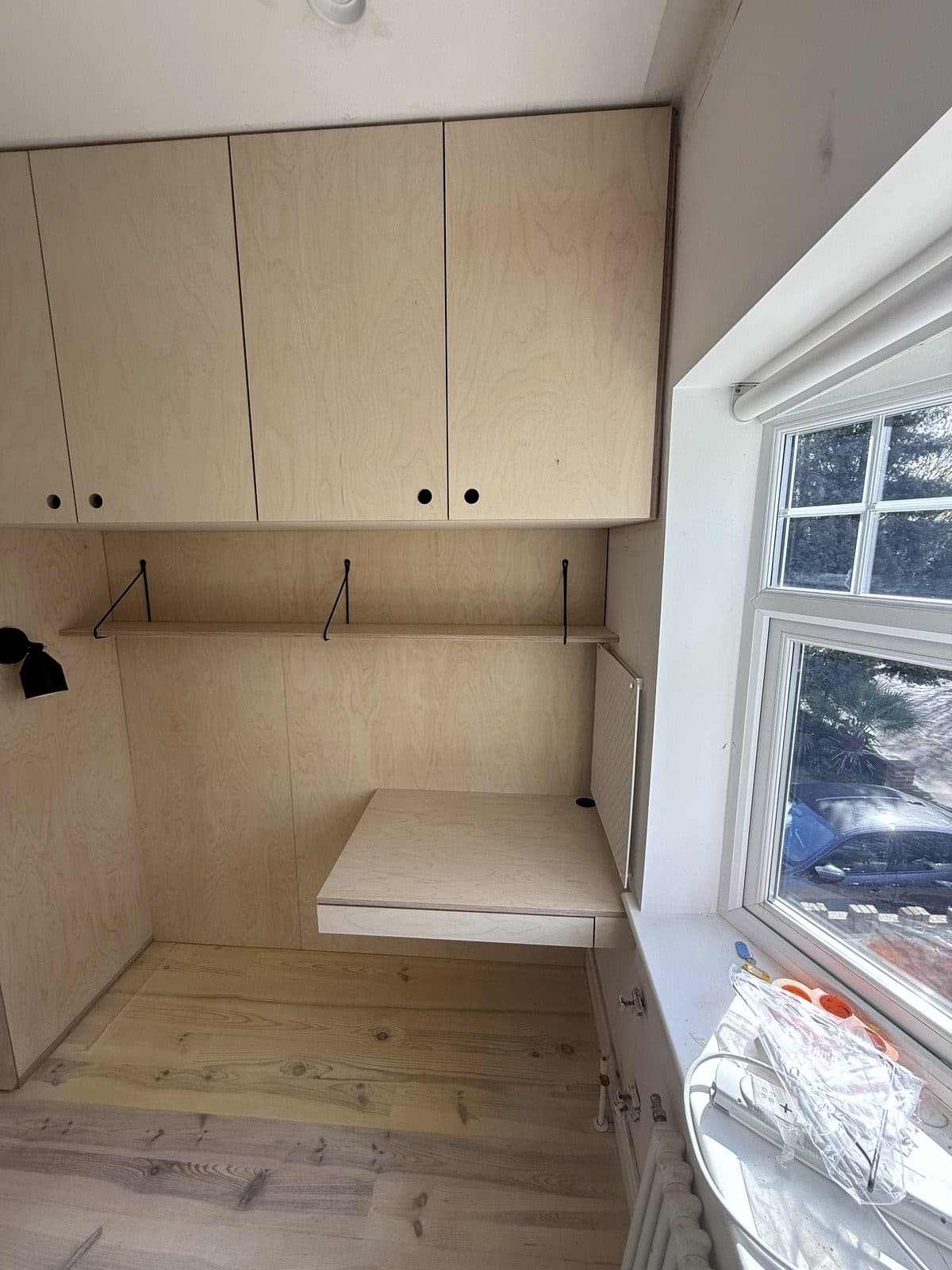 Overhead cupboards and desk by the window