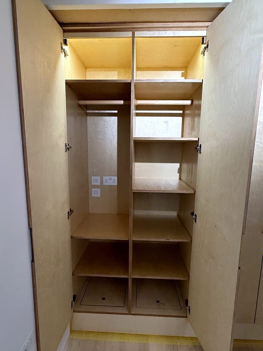 Two doors open: hanging rail, shelves and the strip light along the top