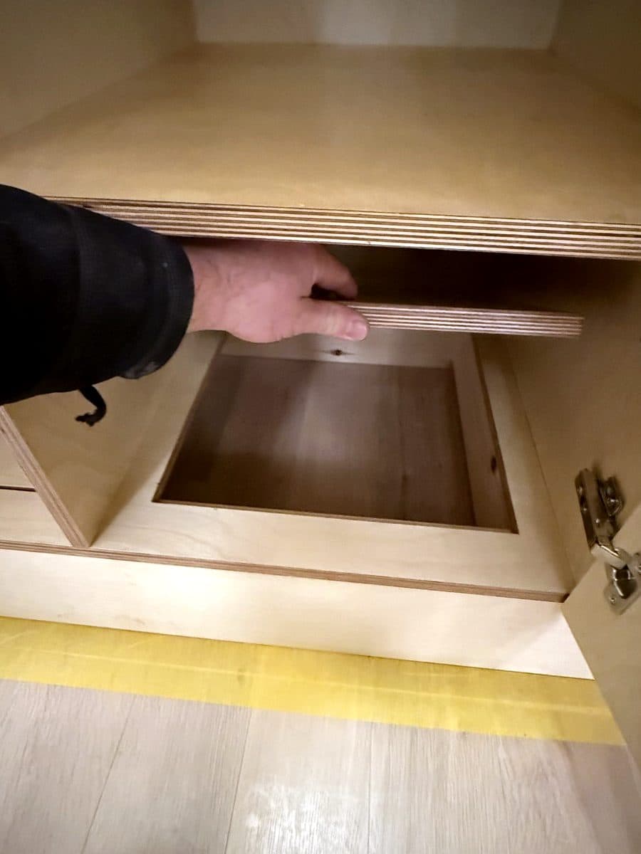 A floor panel lifted out to show the hidden box underneath