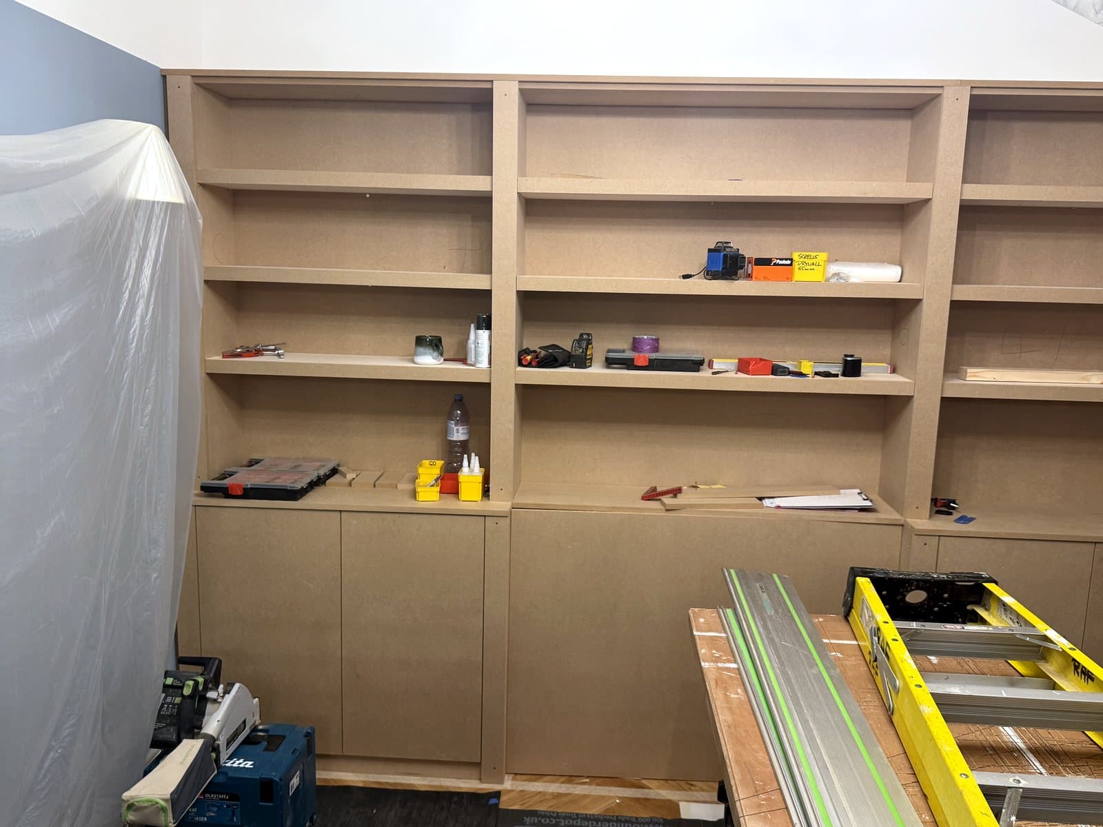 The wall of shelves before the doors