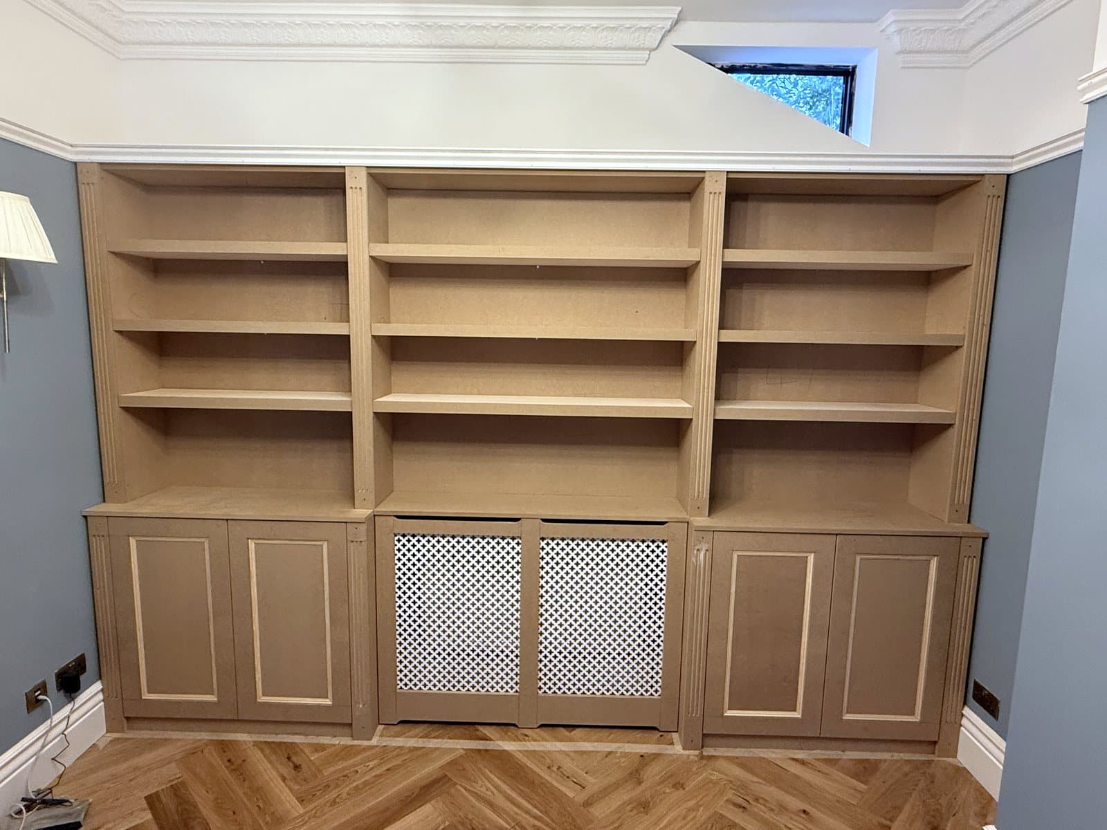 The finished wall of shelves with the doors on