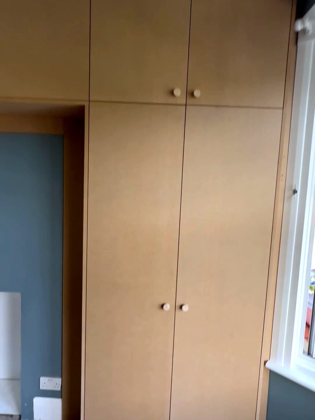 Tall two-door wardrobe with cupboards above