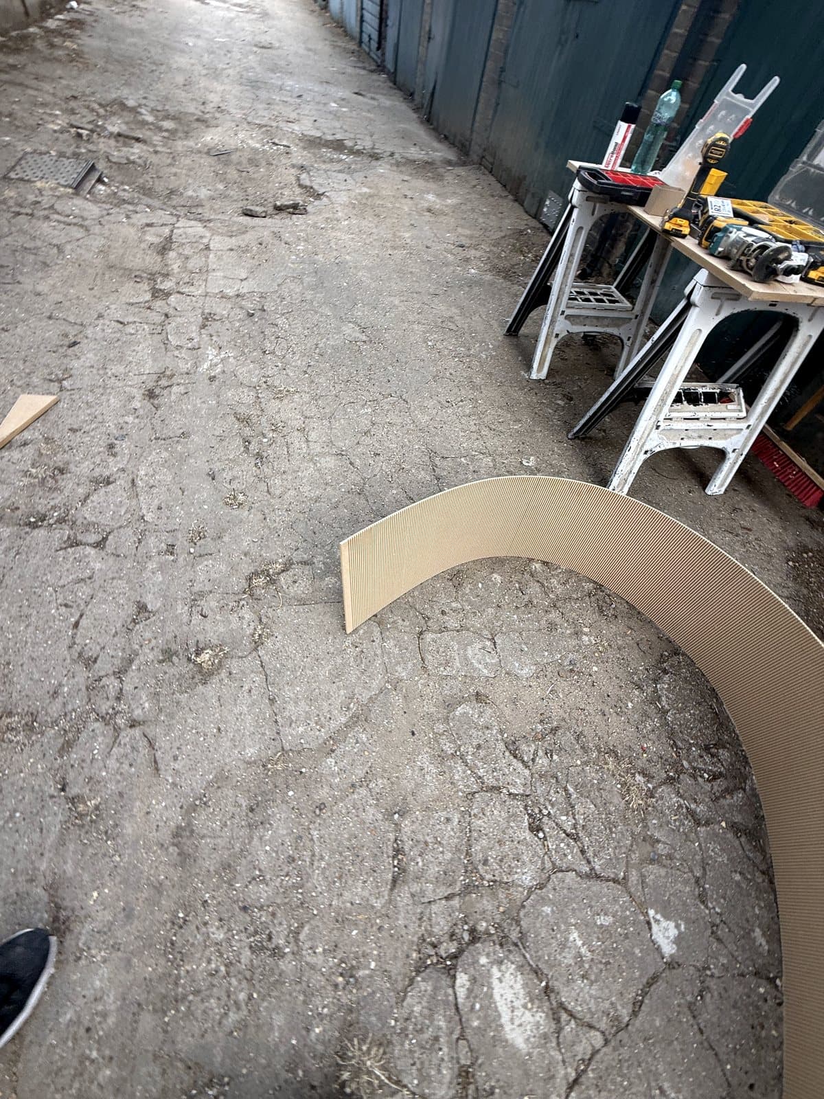 A thin sheet bent into a curve on the ground