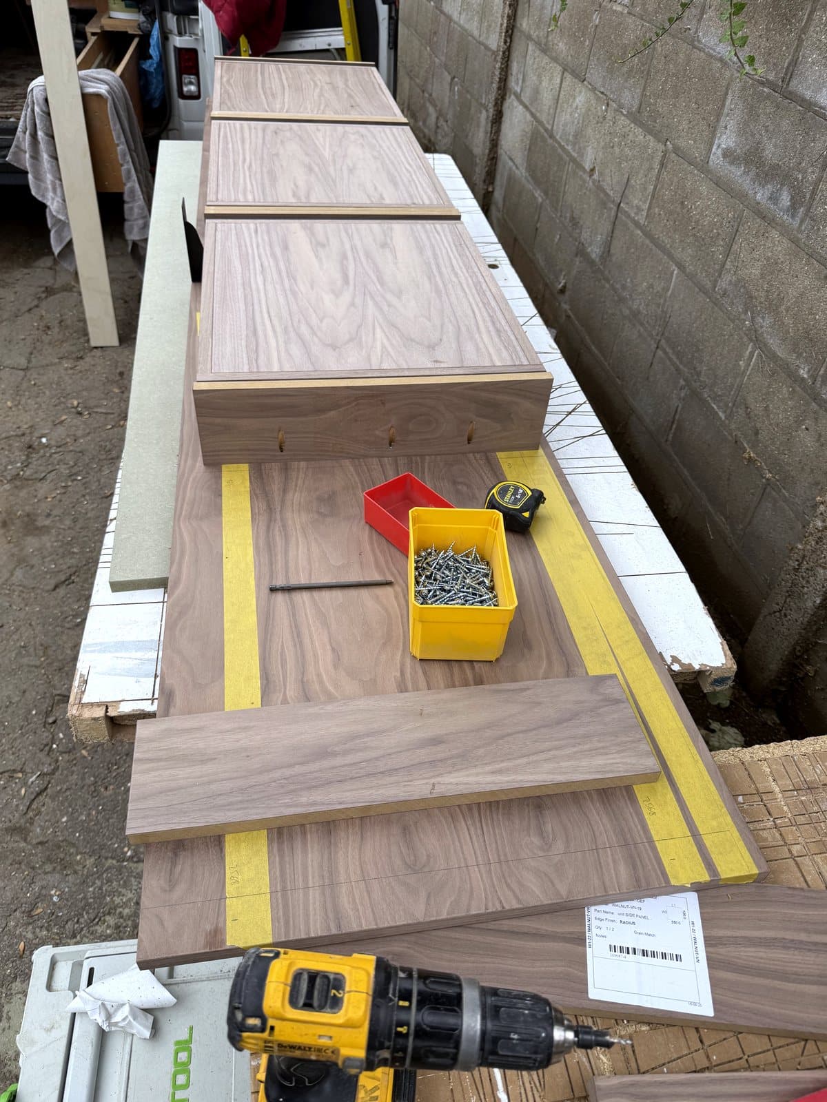 Walnut parts on trestles outside the workshop