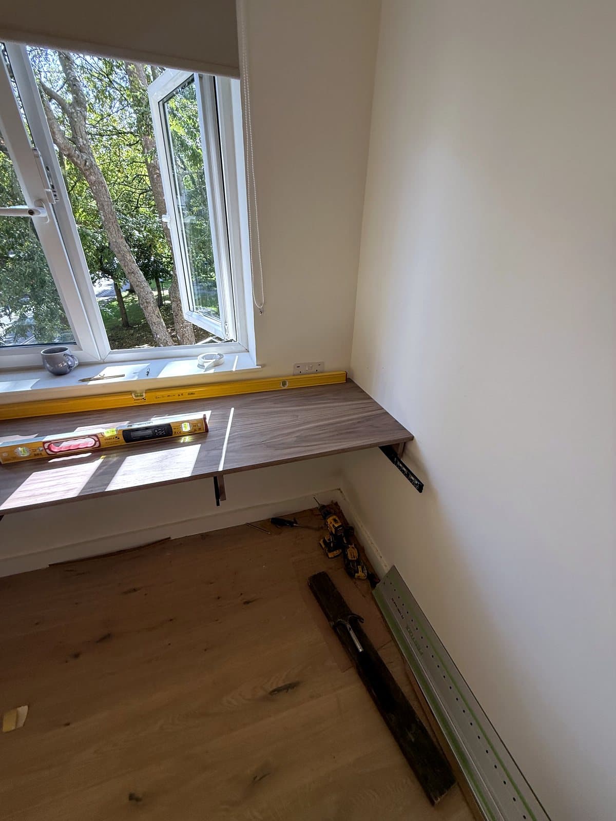 Level checked along the desk by the window