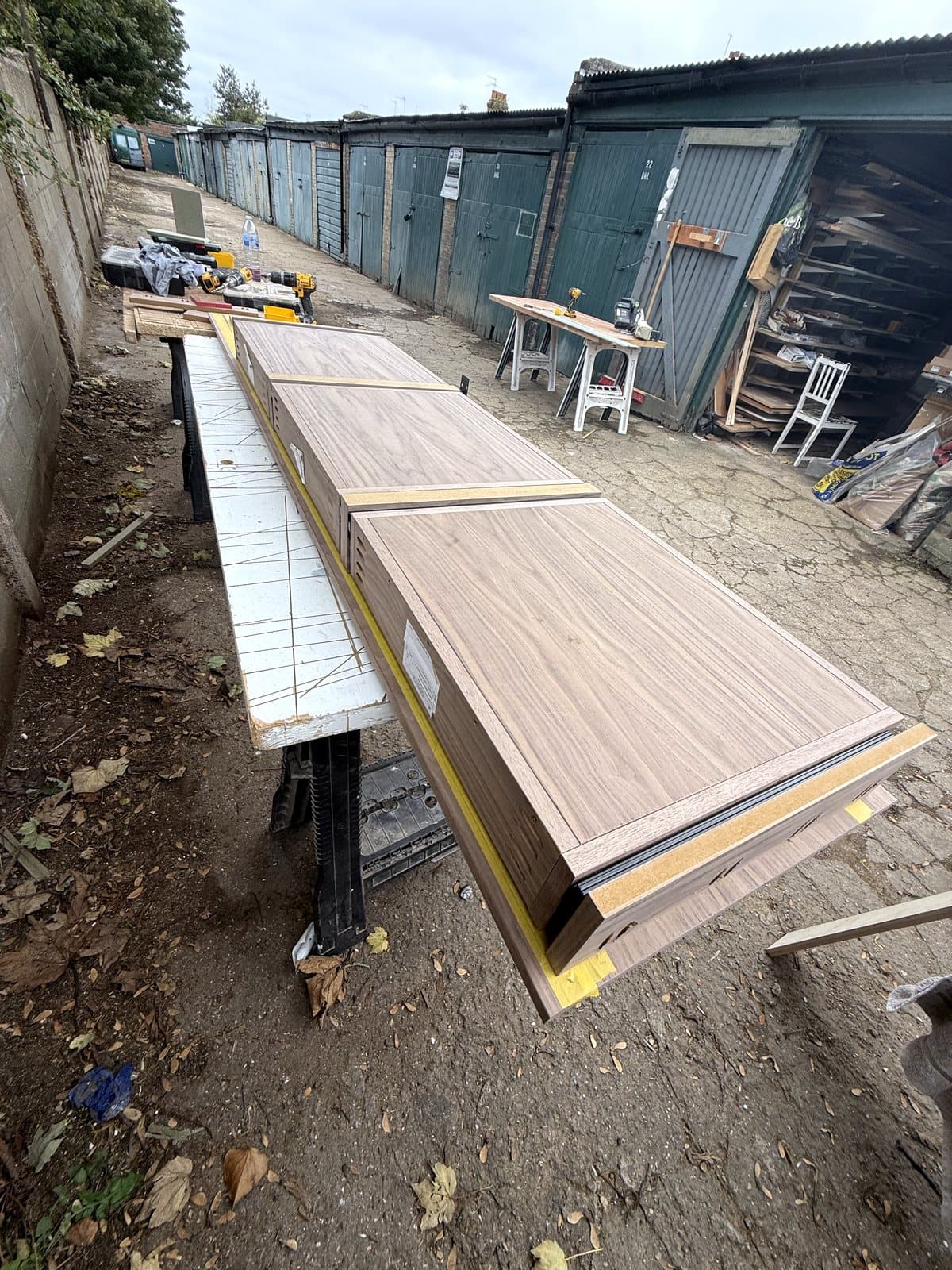 Walnut parts on trestles by the van