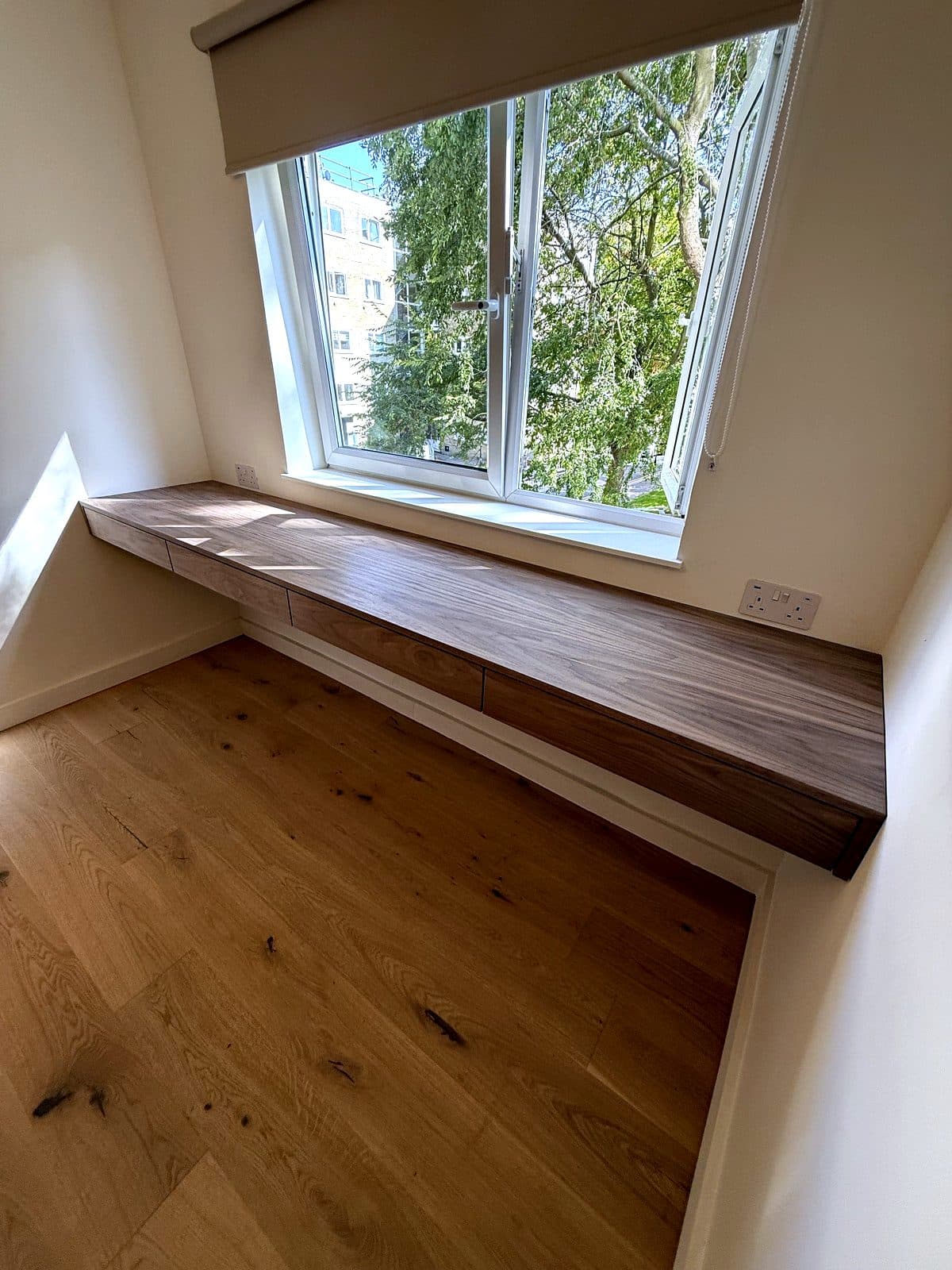 The desk seen from the door, floating above the floor
