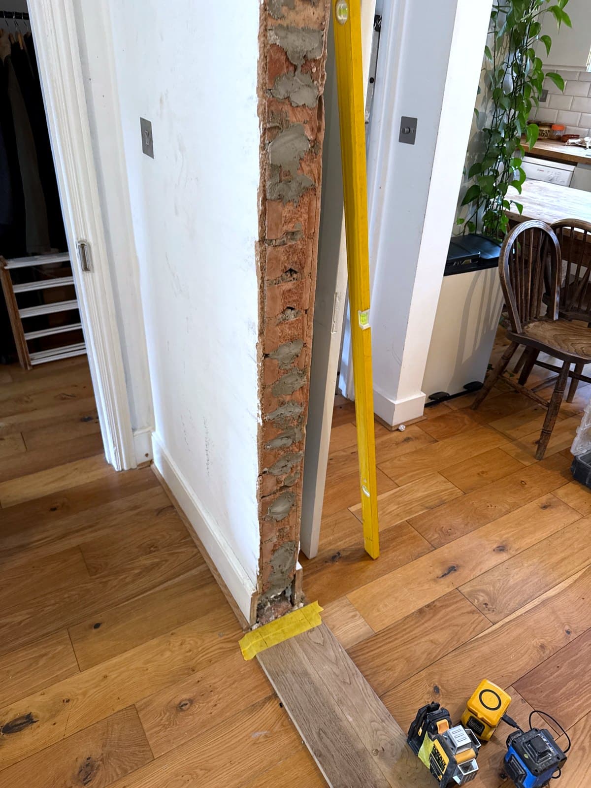 The rough brick edge of the opening with a level against it