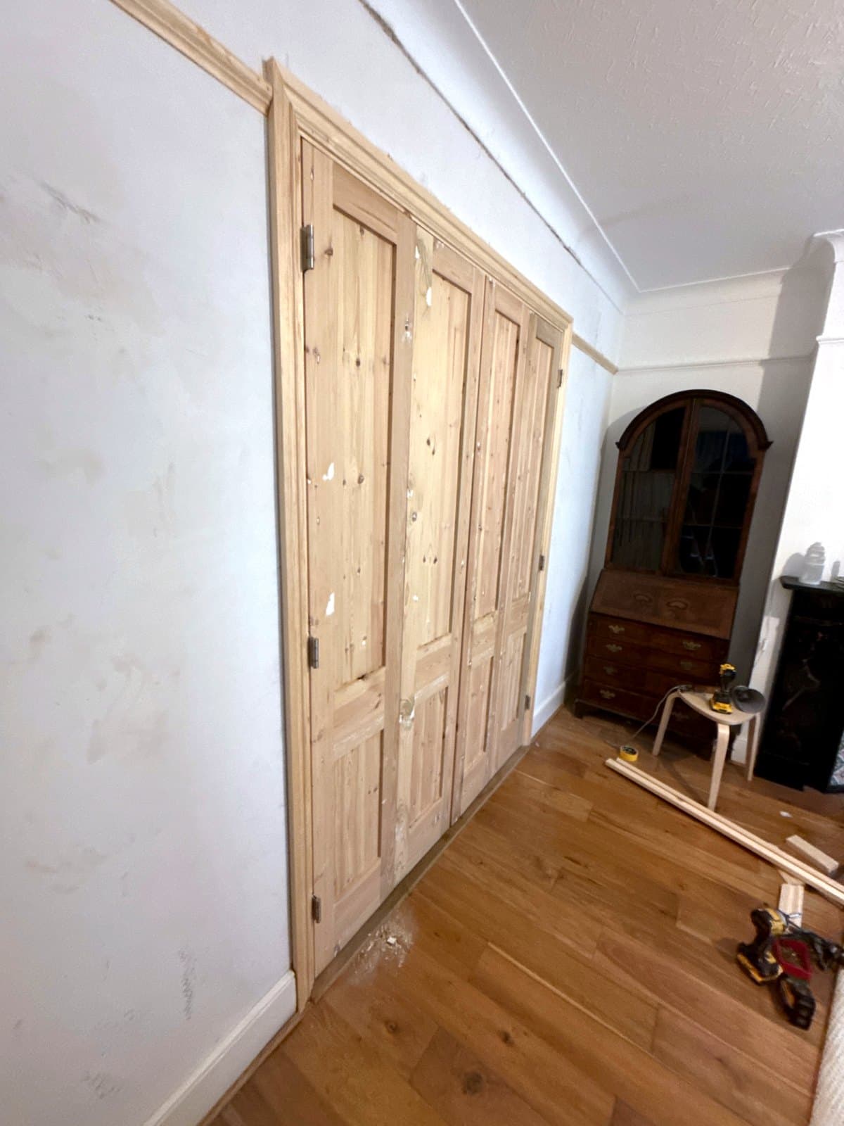 The closed doors from the left, along the wall