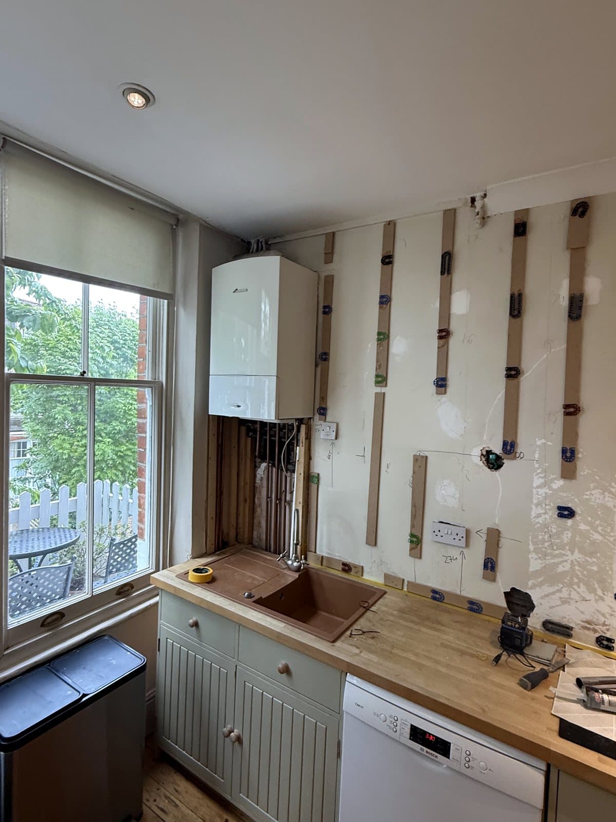 Battens on the wall by the window and boiler