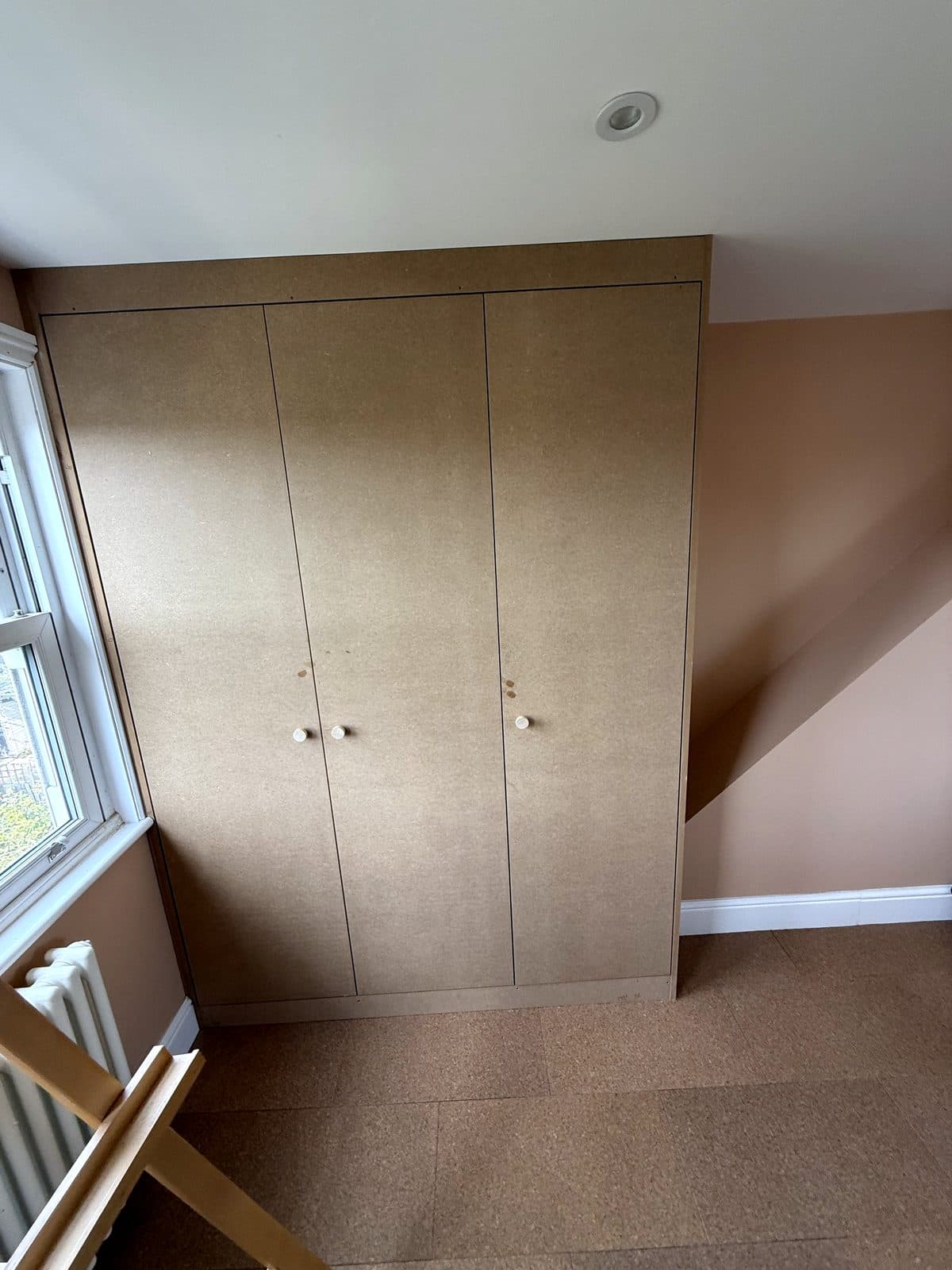 Wardrobe by the window with the easel in front