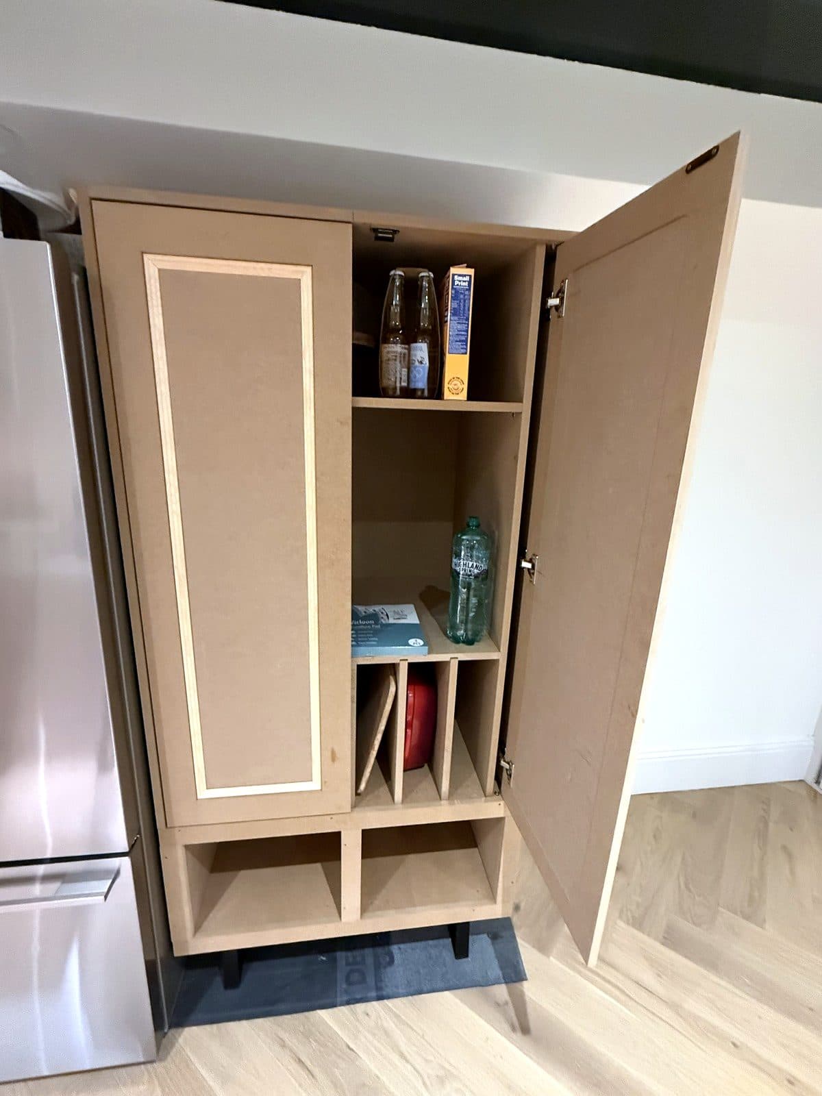 One door open showing shelves and upright dividers