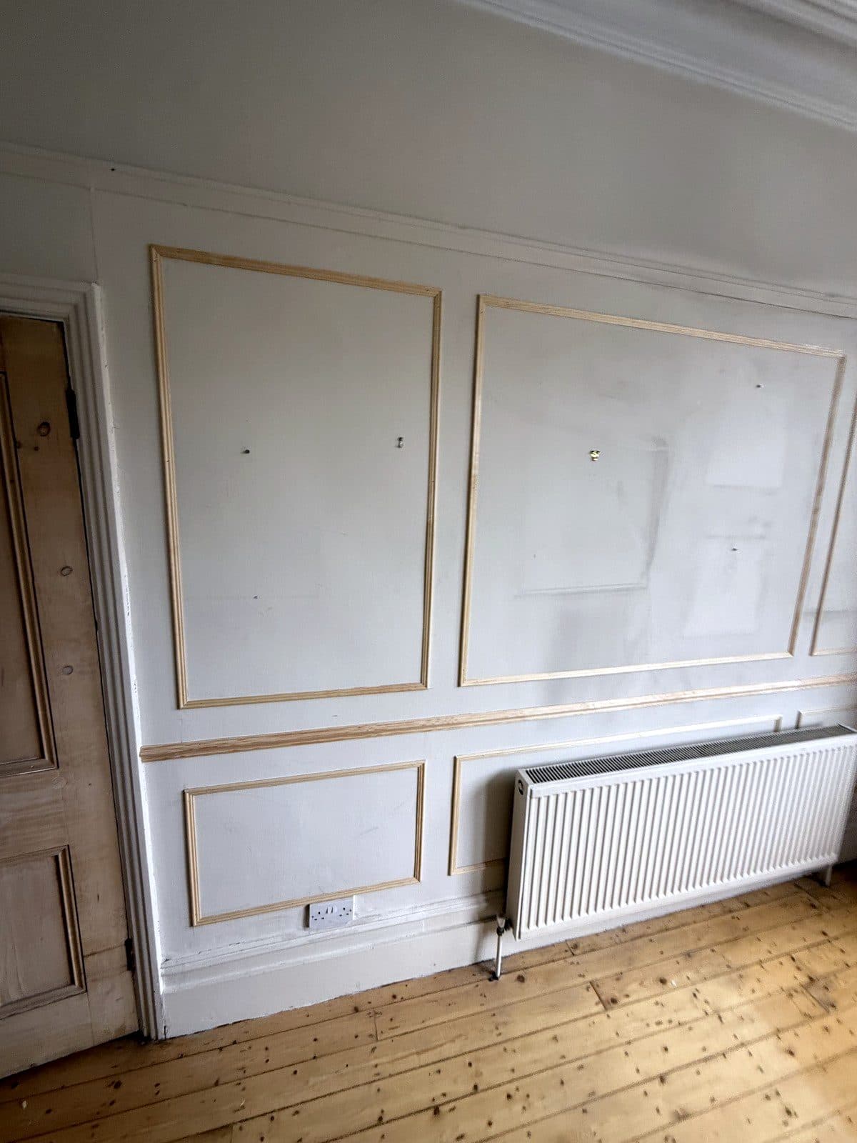 Frames spaced evenly along the wall above the radiator