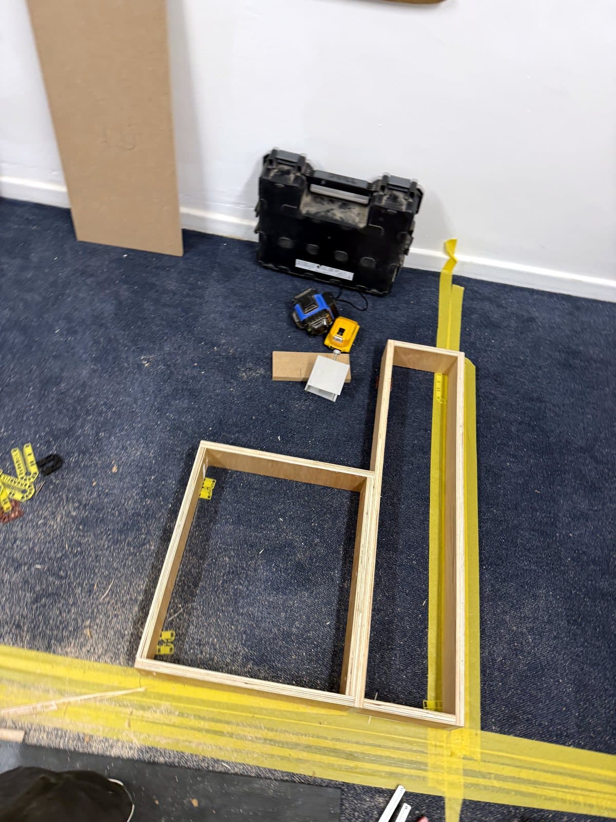 L-shaped plinth frames following the tape