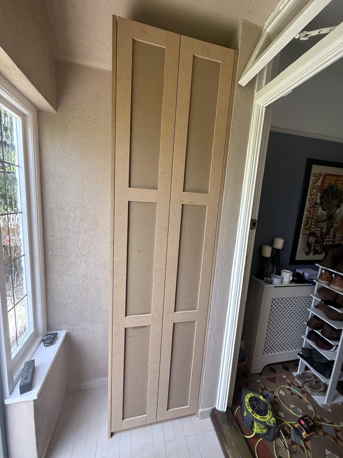 Tall cupboard with panelled doors