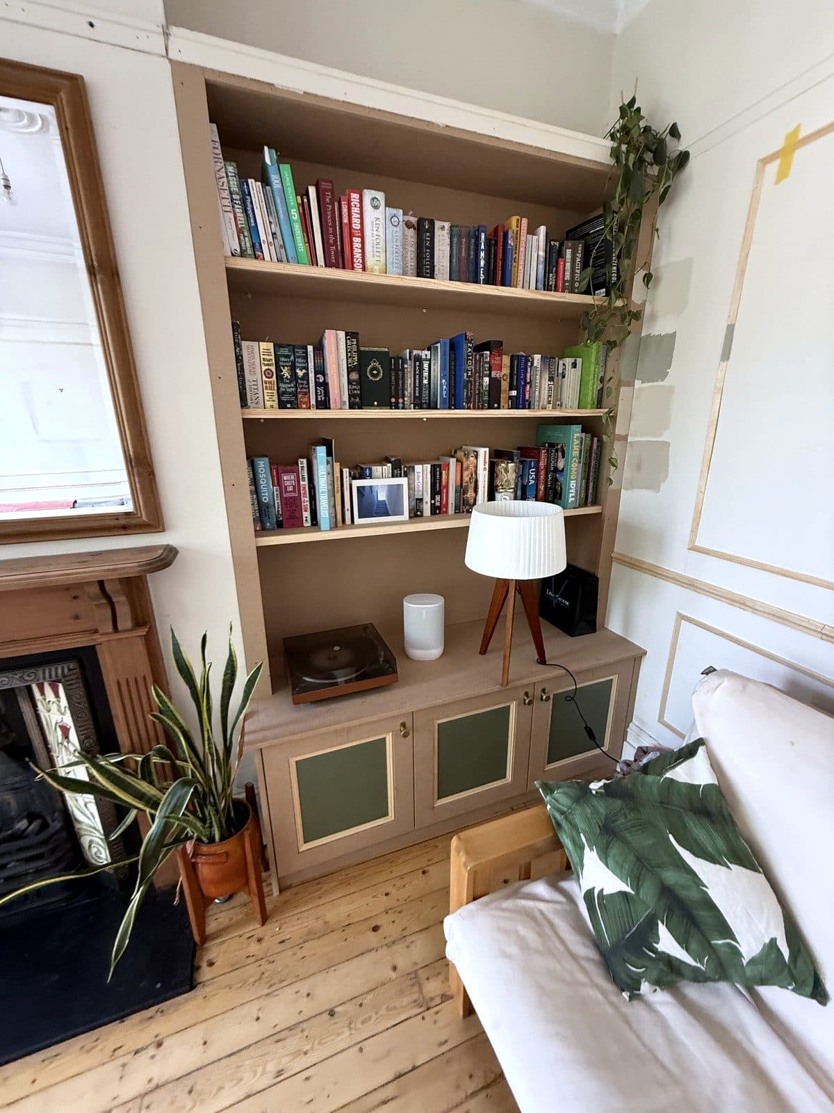 The bookcase seen from the sofa, beside the fireplace