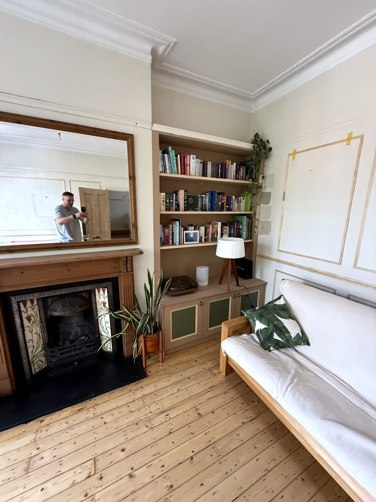 Fireplace with the bookcase to the right and panelling on the next wall