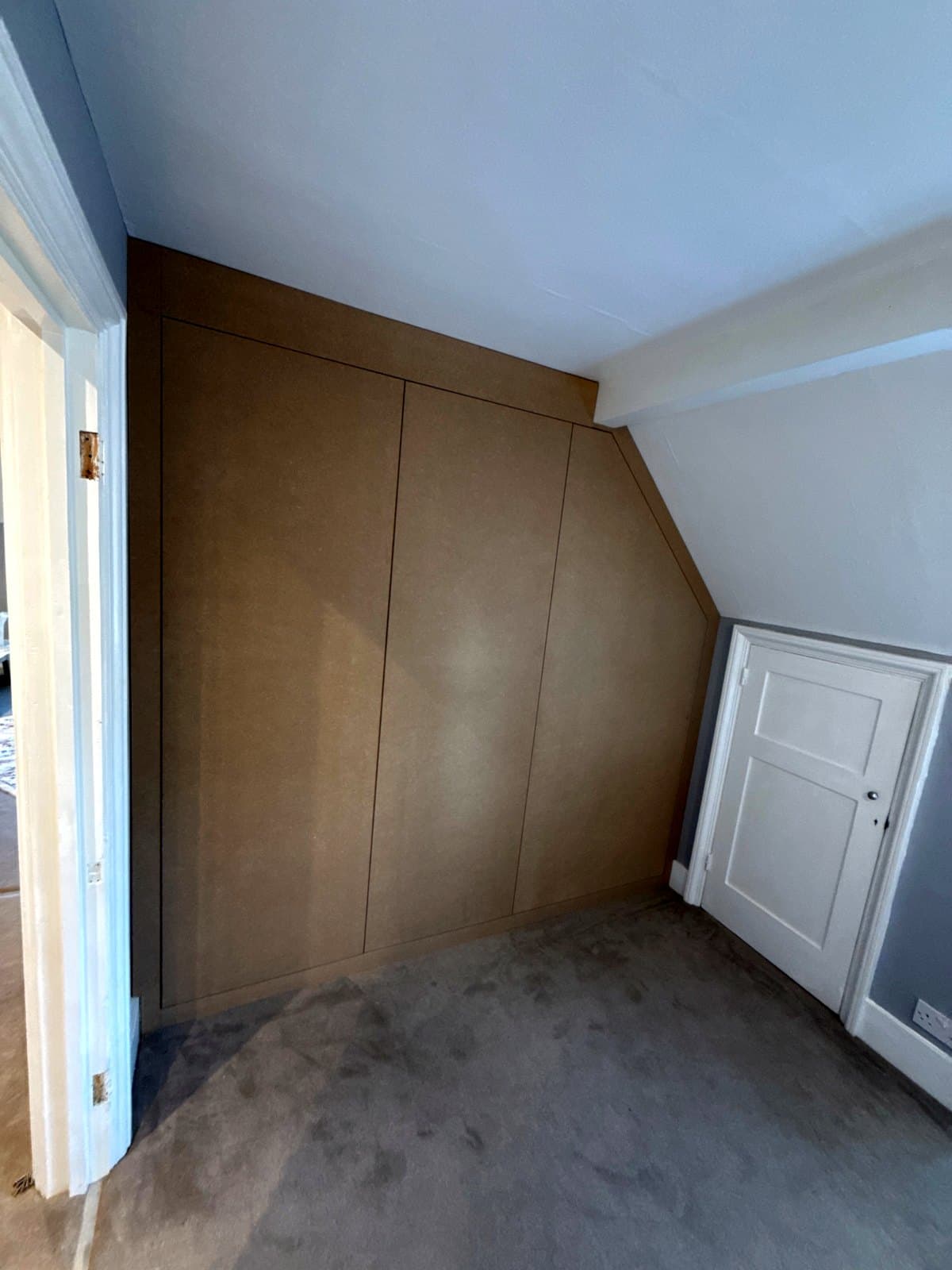 The finished wardrobe across the end of the loft room