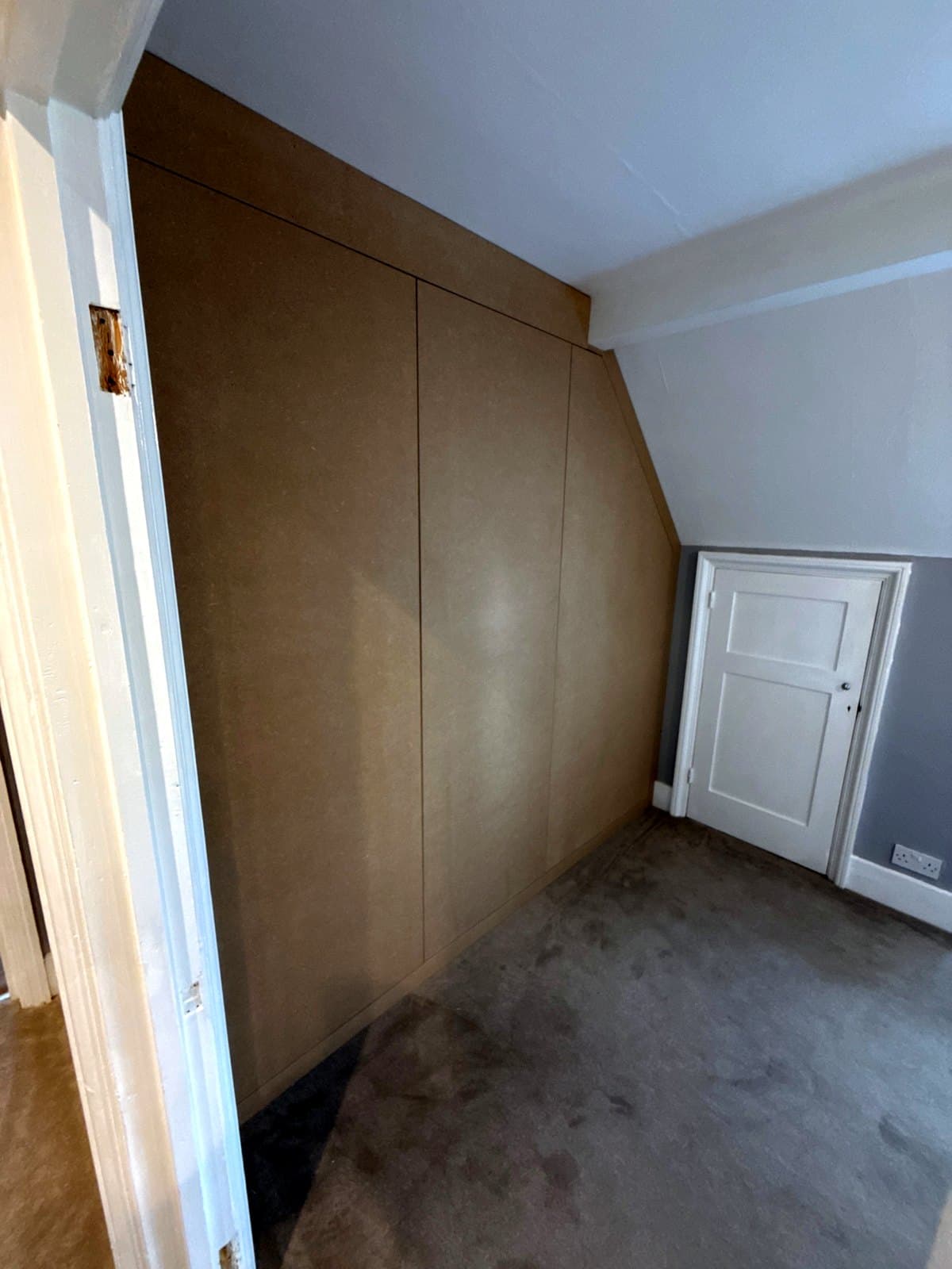 The wardrobe from the left, with the sloped door by the small door