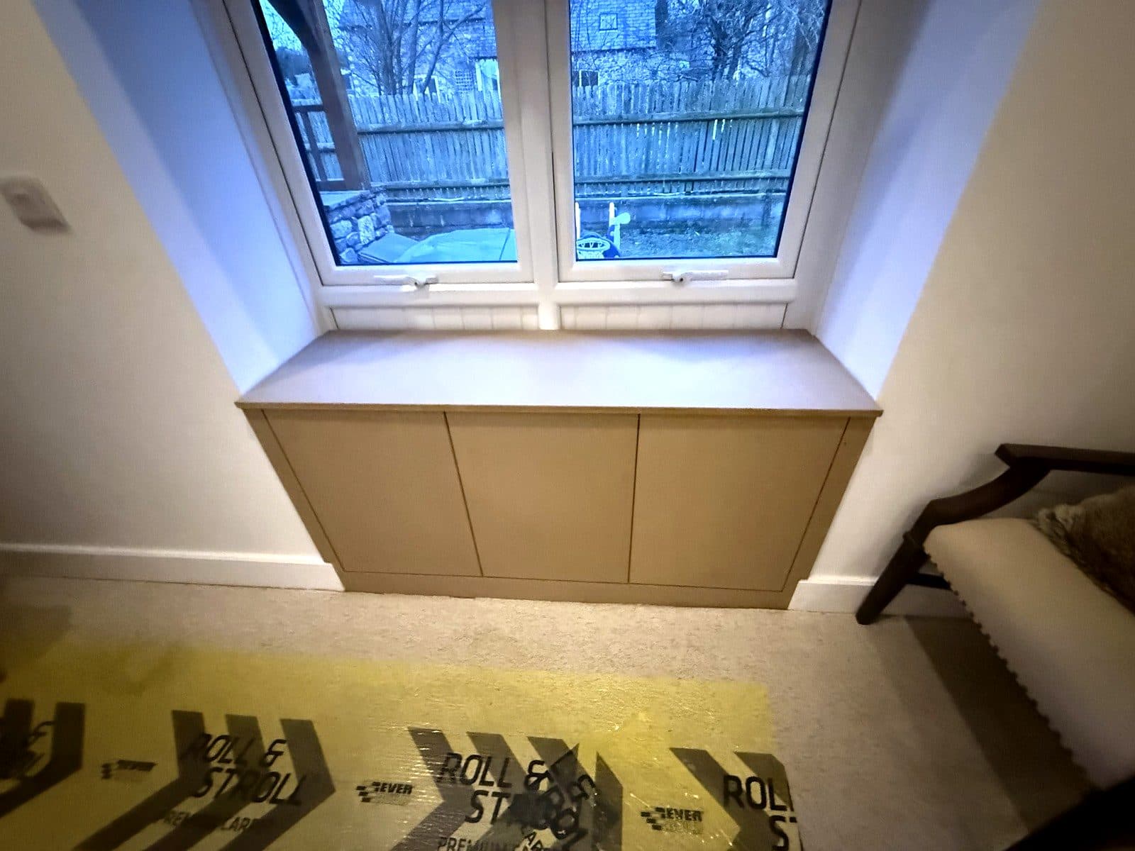 The seat and cupboards from across the room