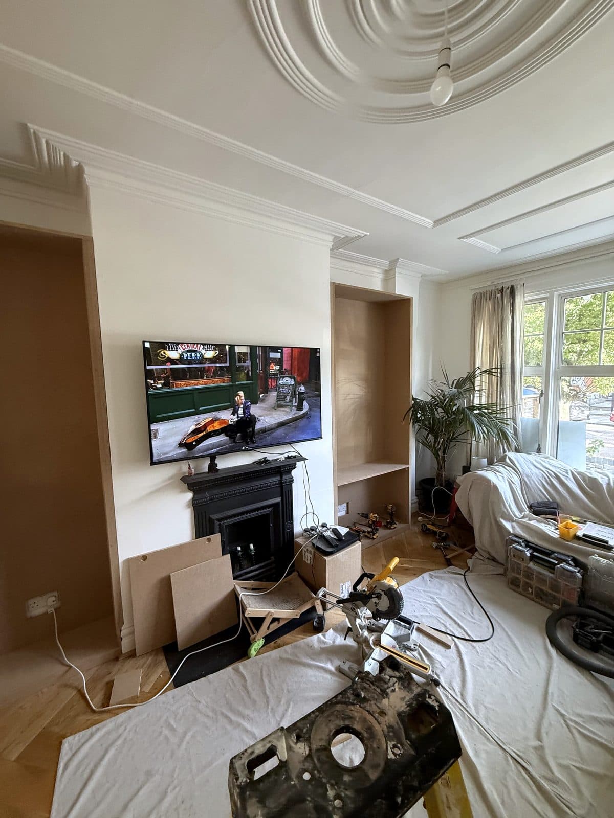 Both alcoves lined with MDF, saw set up on dust sheets in the room