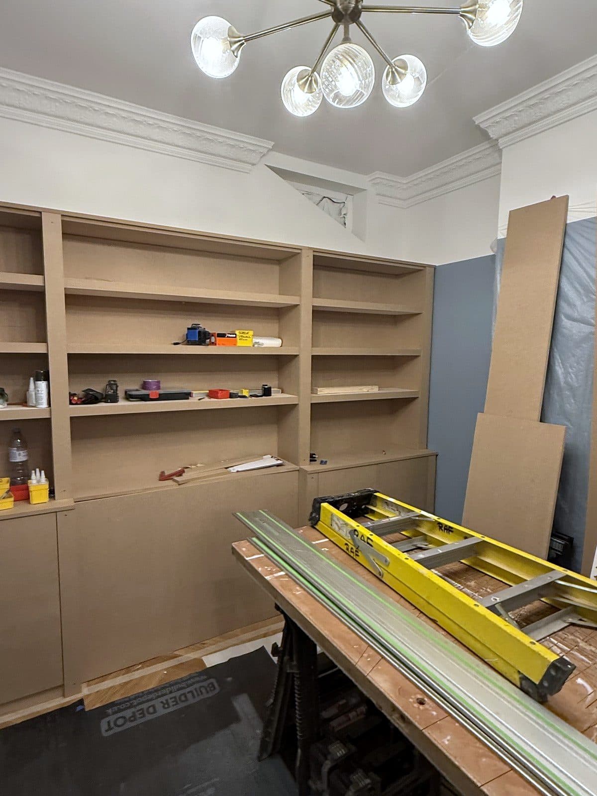 Shelves fitted in all three bays with cupboards underneath
