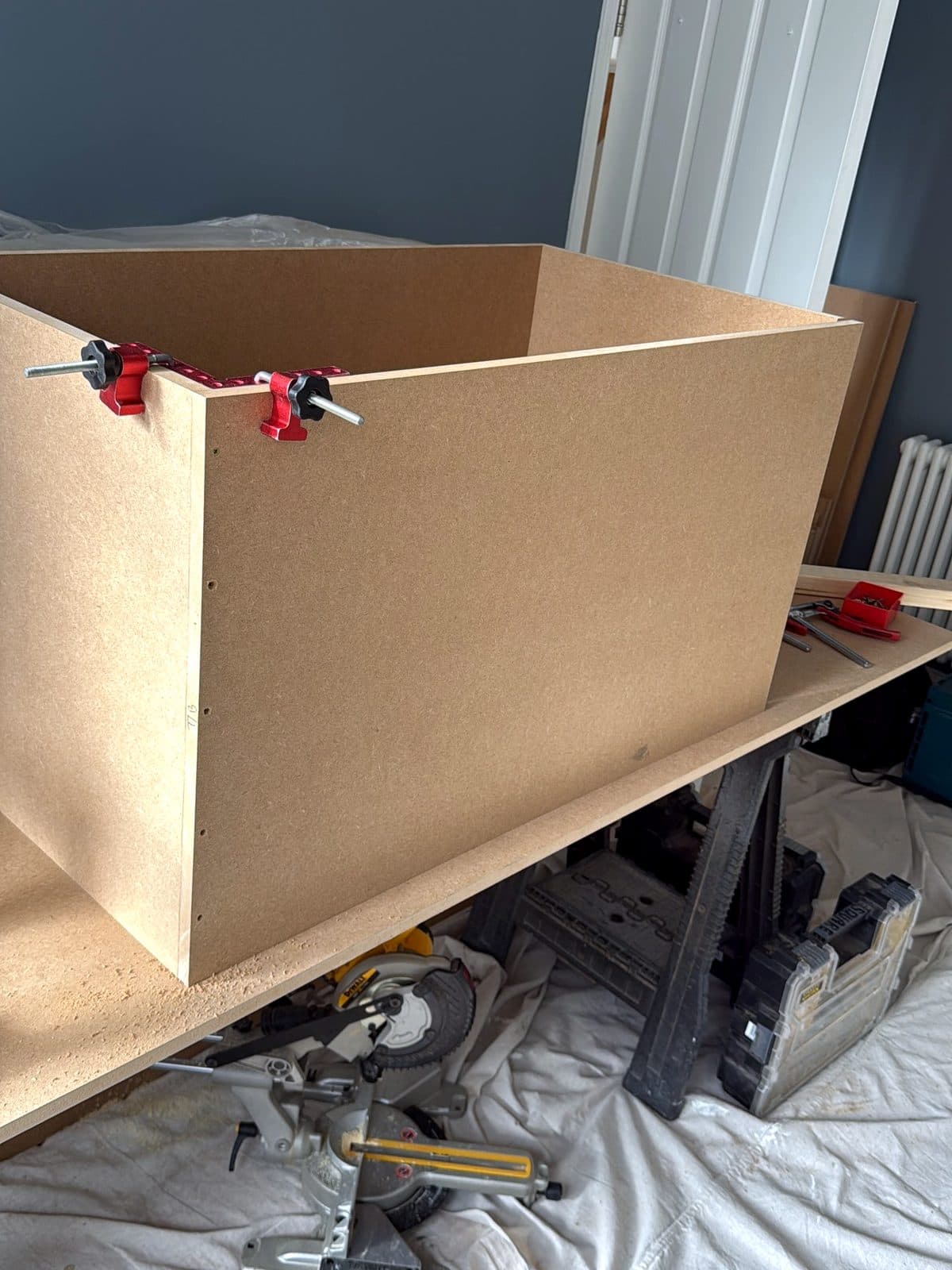 MDF box held with clamps on a workbench