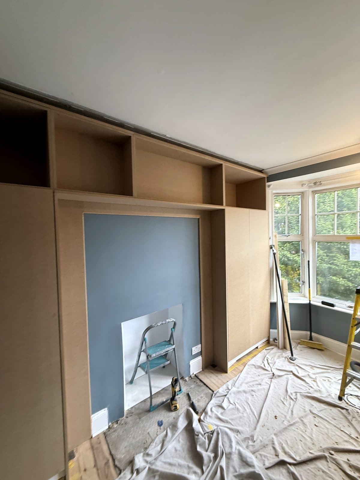 Tall MDF doors fitted either side of the chimney breast