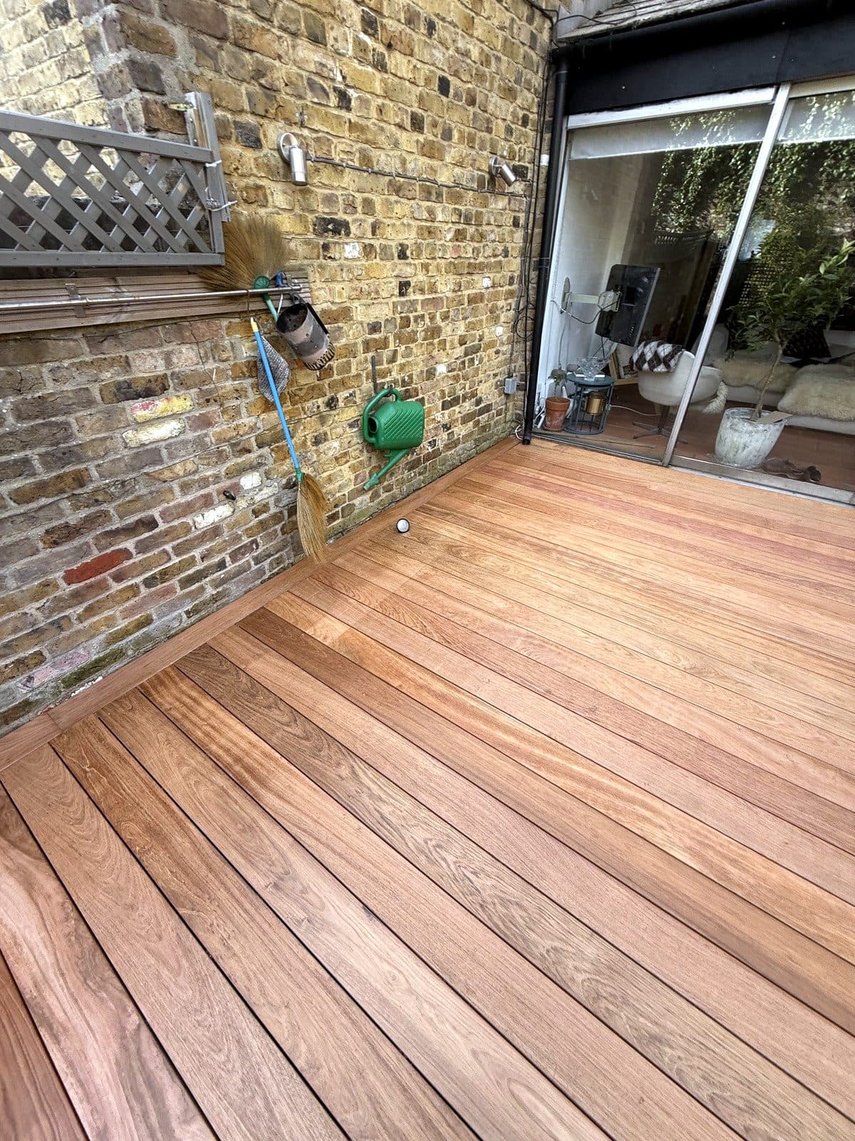 Timber decking across a walled courtyard garden