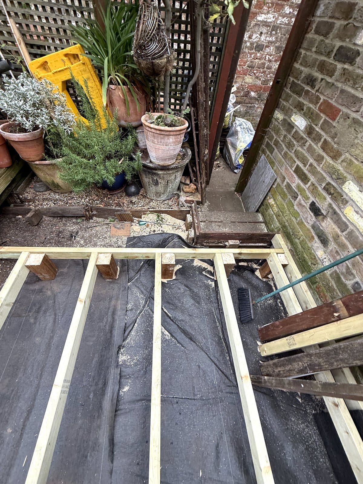 Joists sitting on blocks at the far end of the garden