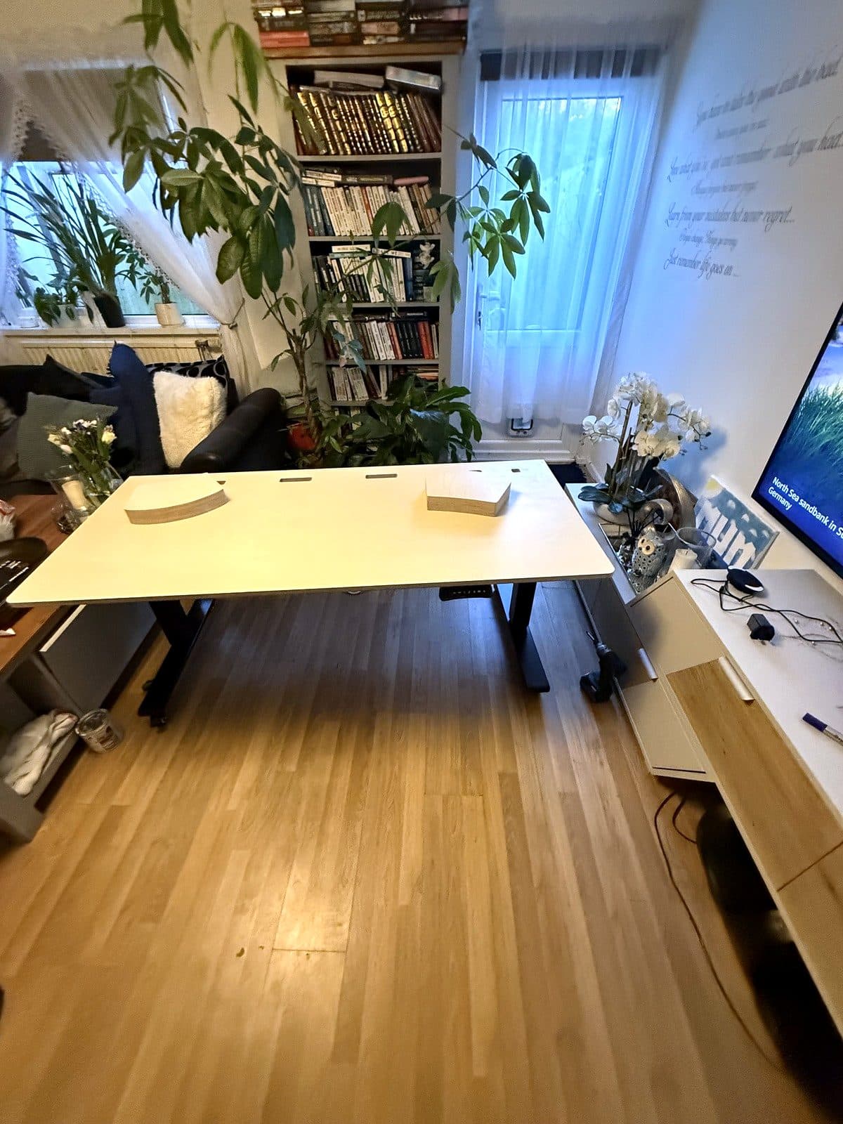 Desk with a pale top and two shaped birch ply stands in a home office