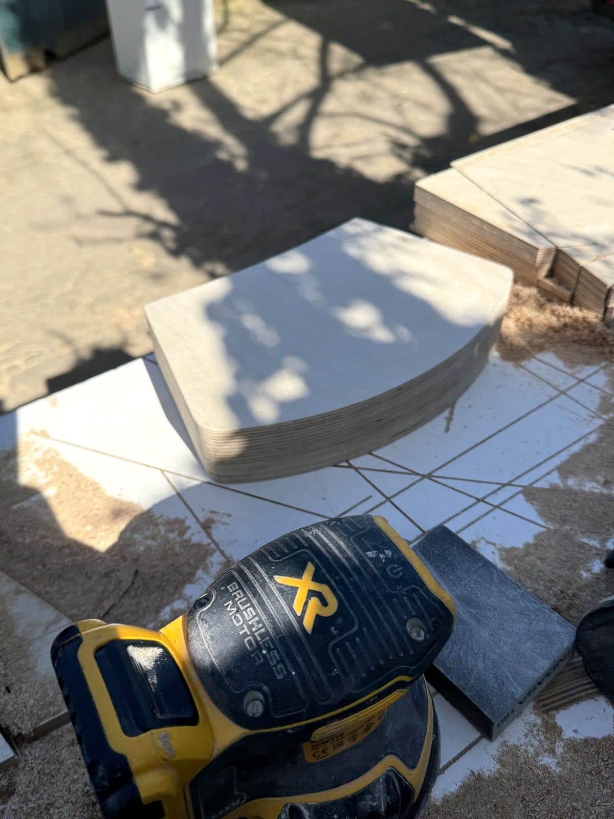 Shaped piece next to a sander