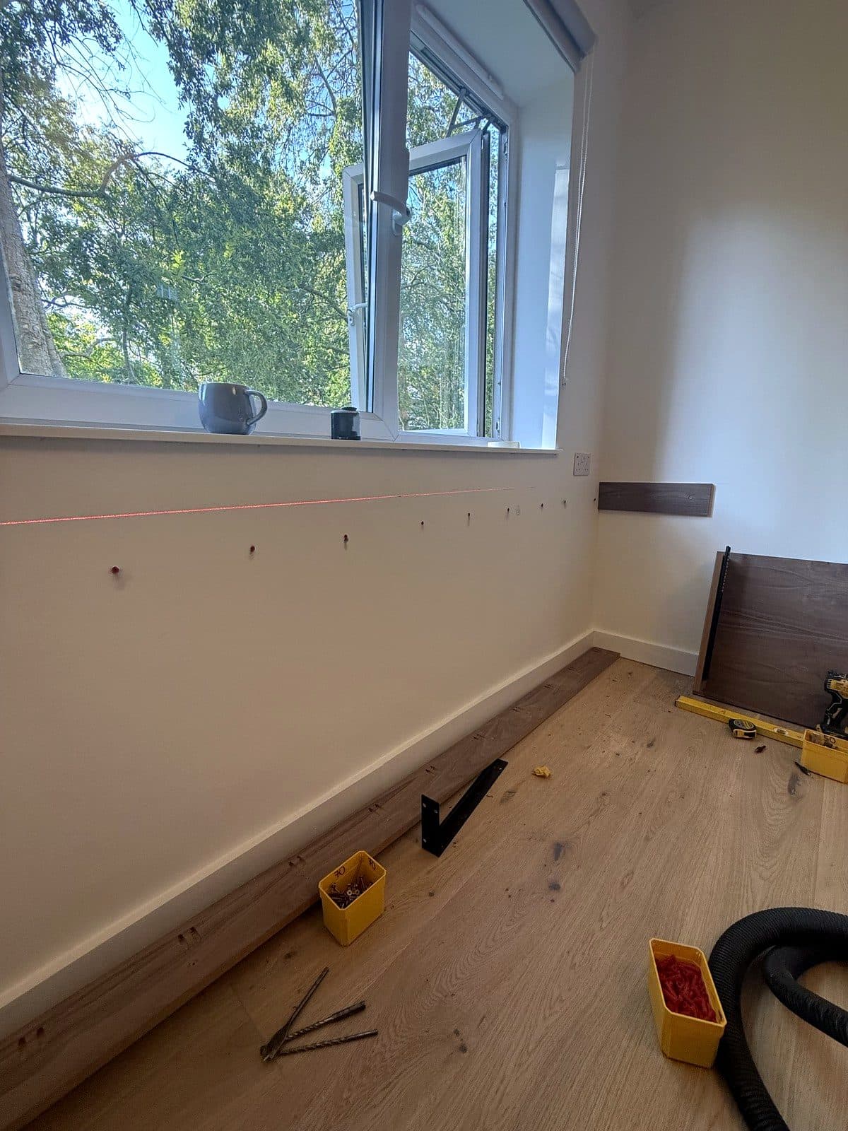 Level line and fixing holes along the wall under the window