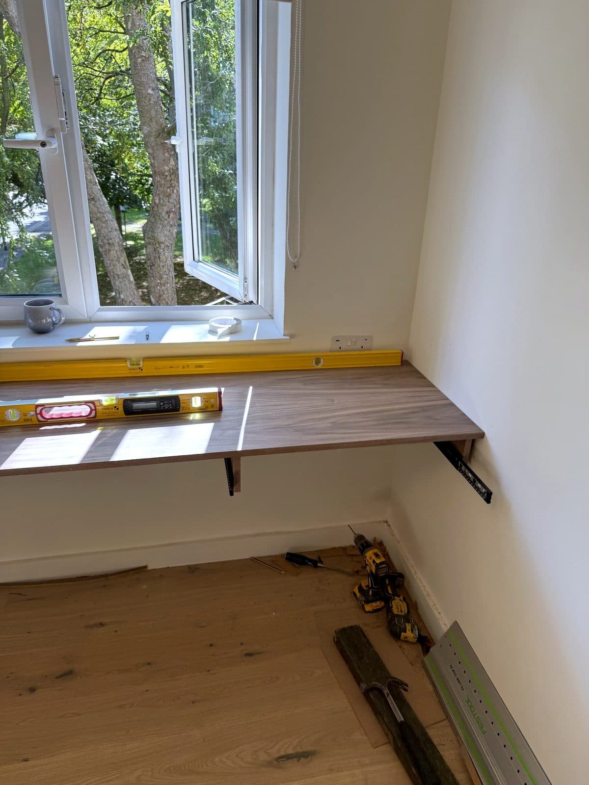 Yellow spirit level on the fitted desk top