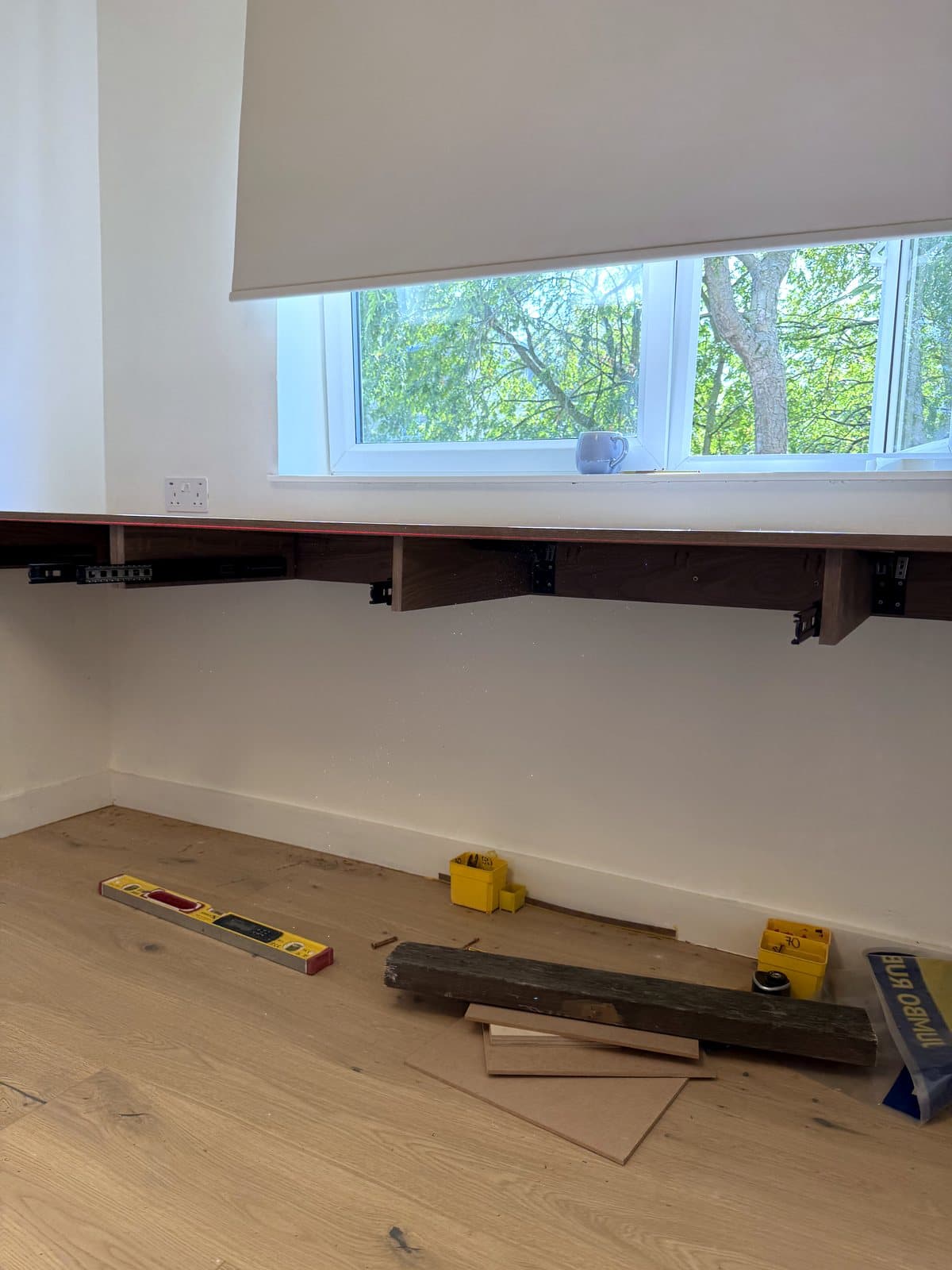 The top fixed under the window with the drawer runners underneath