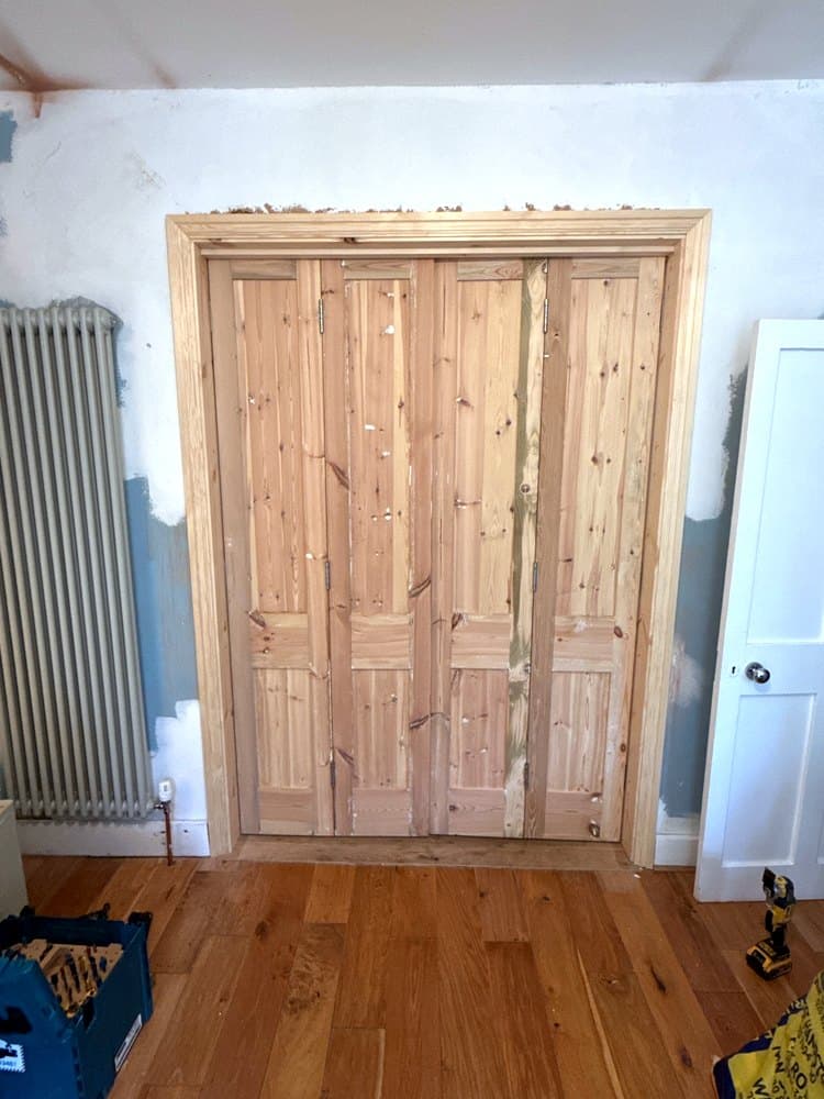The same opening after: a new frame, architraves and four folding doors