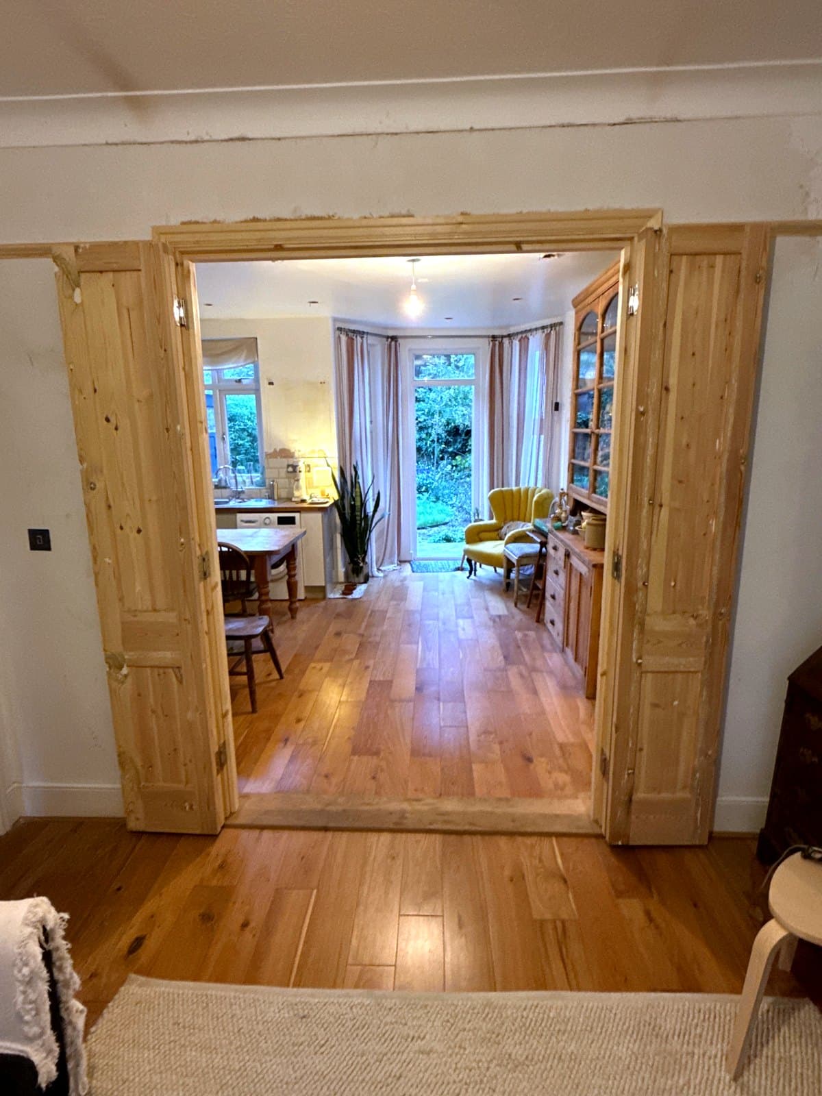 The doors folded back in pairs at each side, looking through to the back room