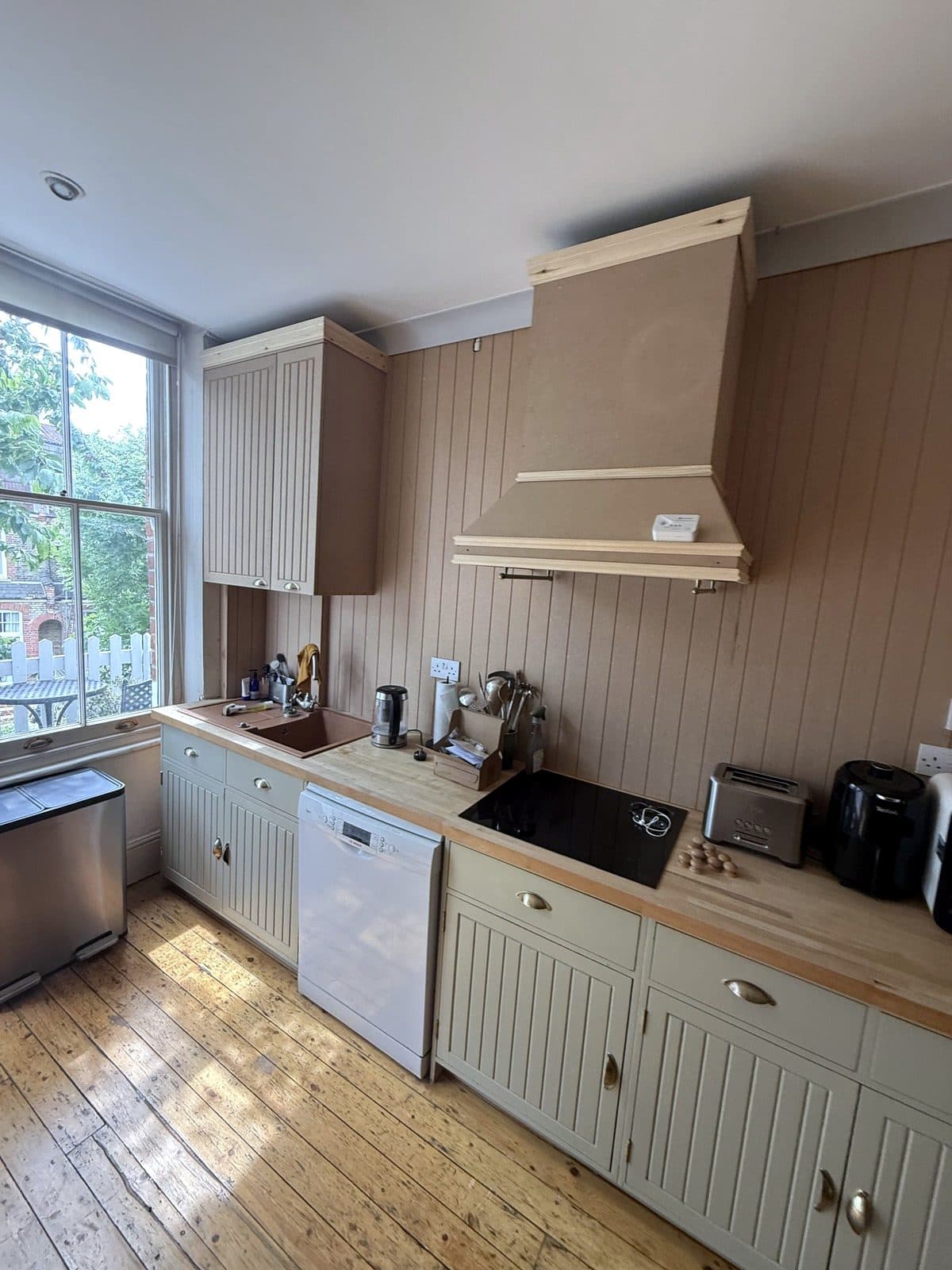 Curved MDF storage bench in a kitchen bay next to a round table