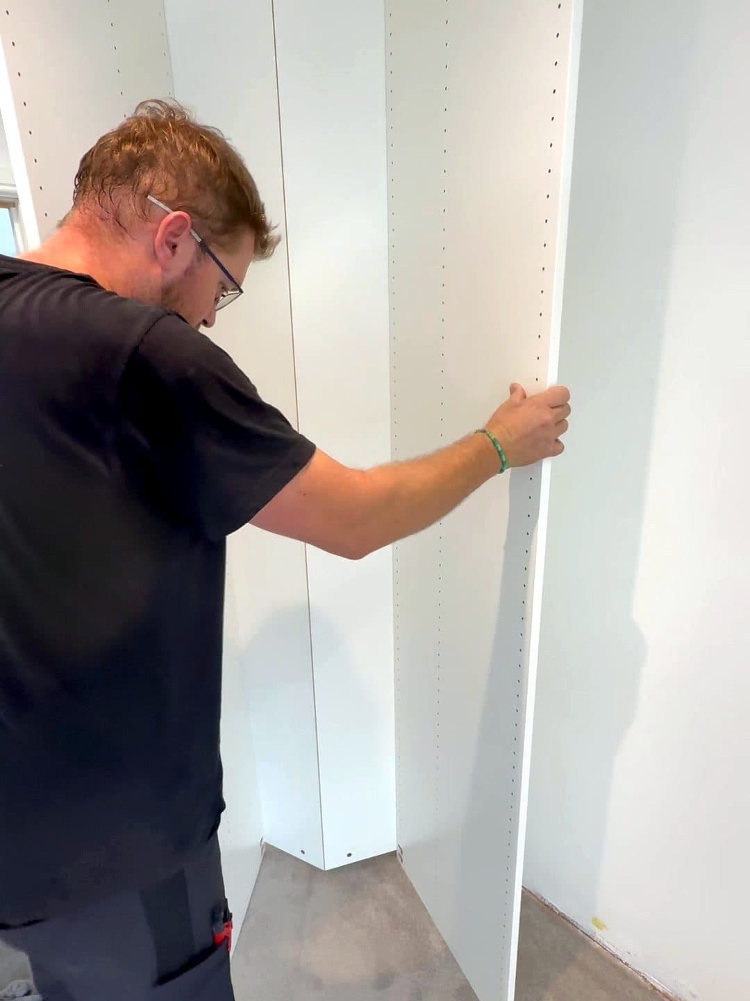 Raf standing a PAX frame up against the wall