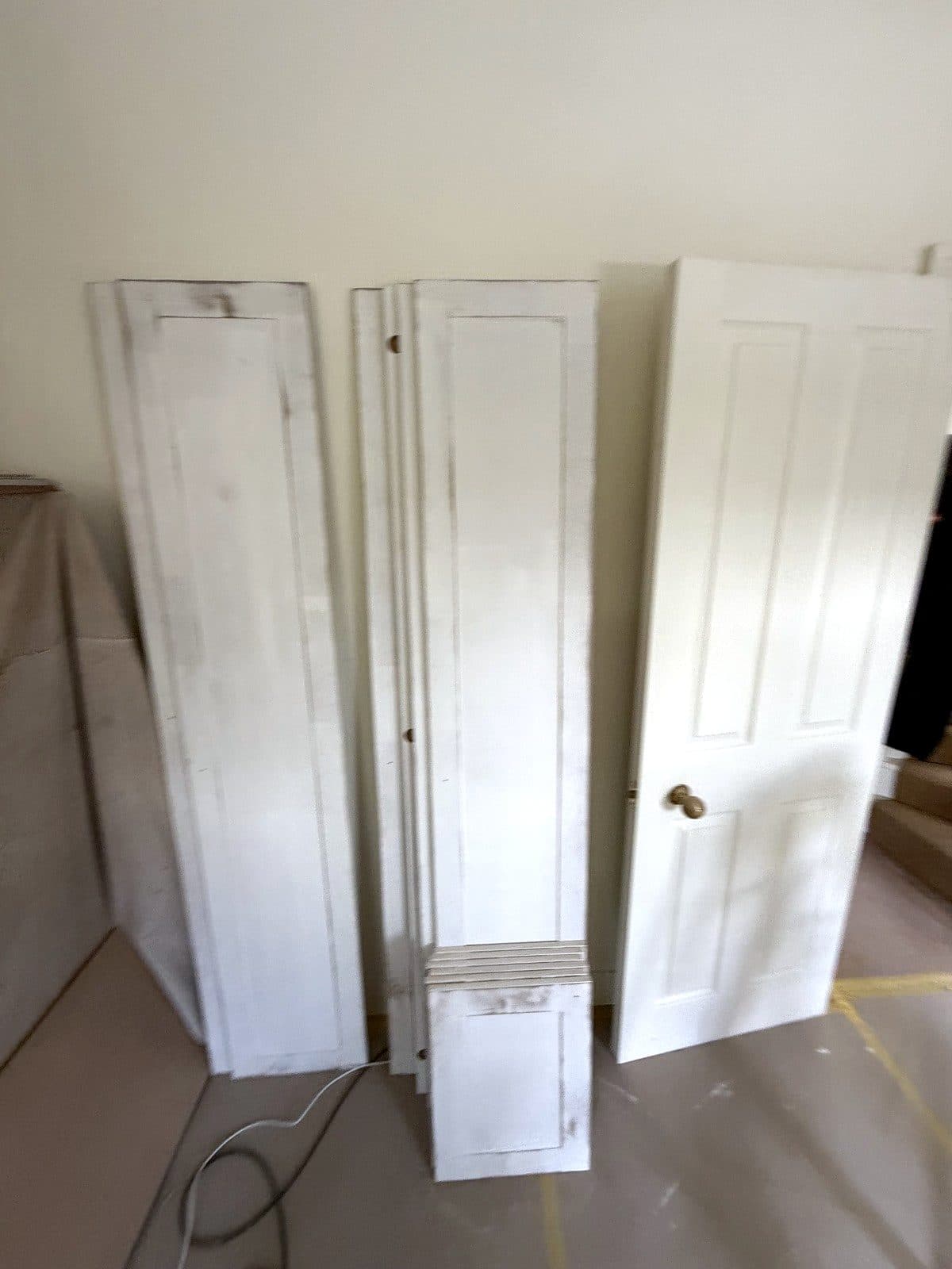 Panelled doors laid out for painting