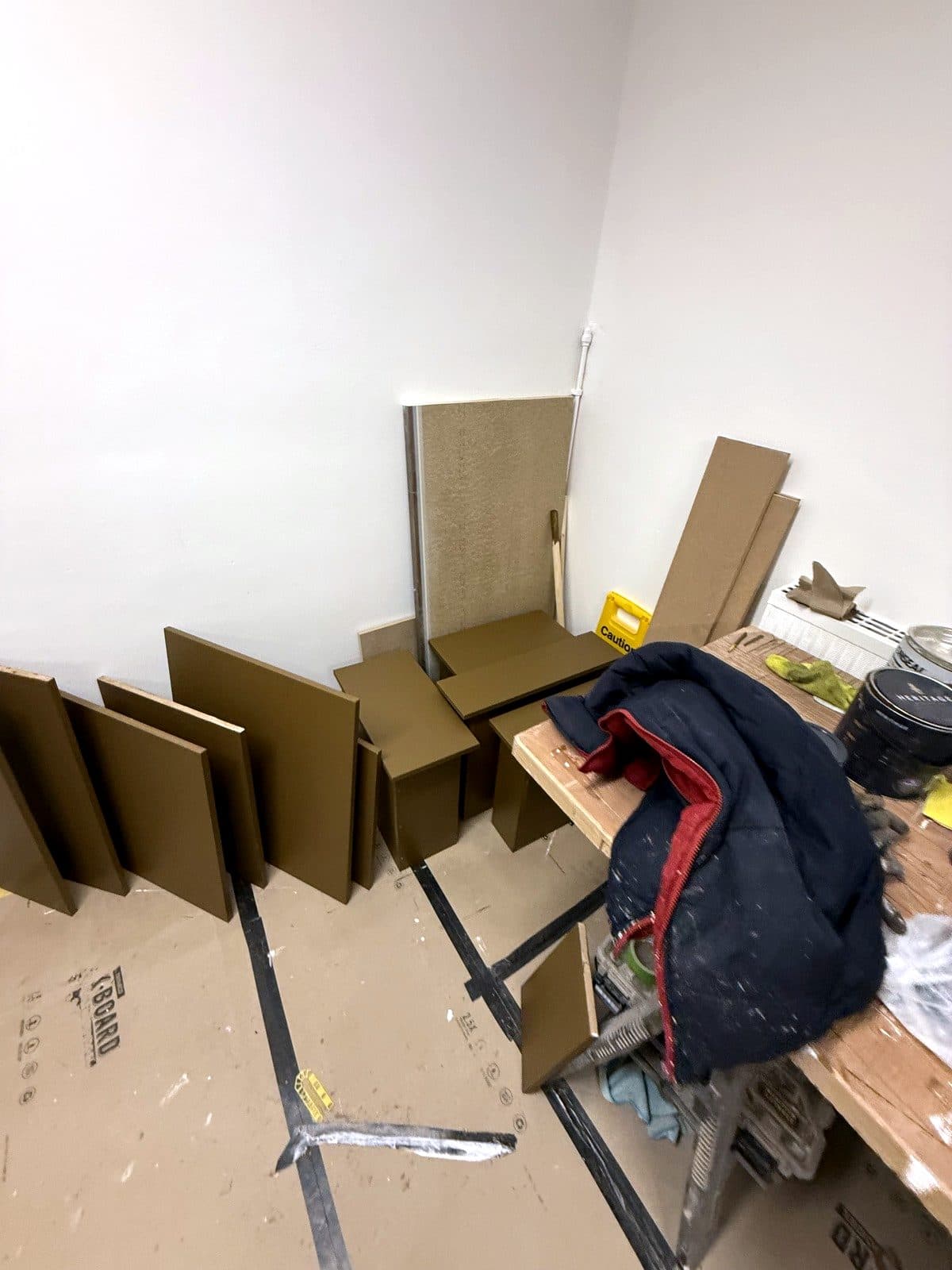 Painted panels laid out on a protected floor