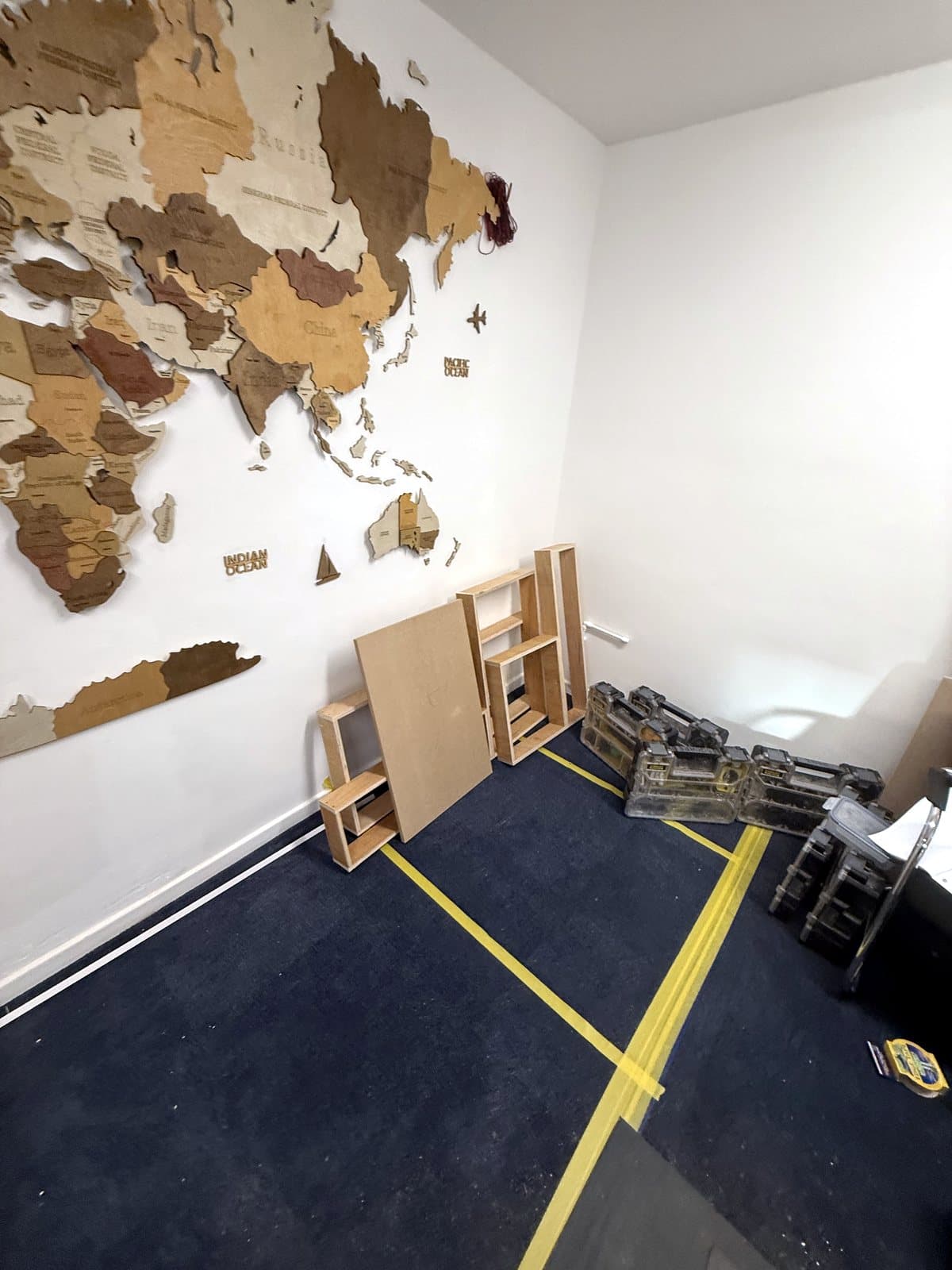 Yellow tape lines on the office carpet marking out the desk