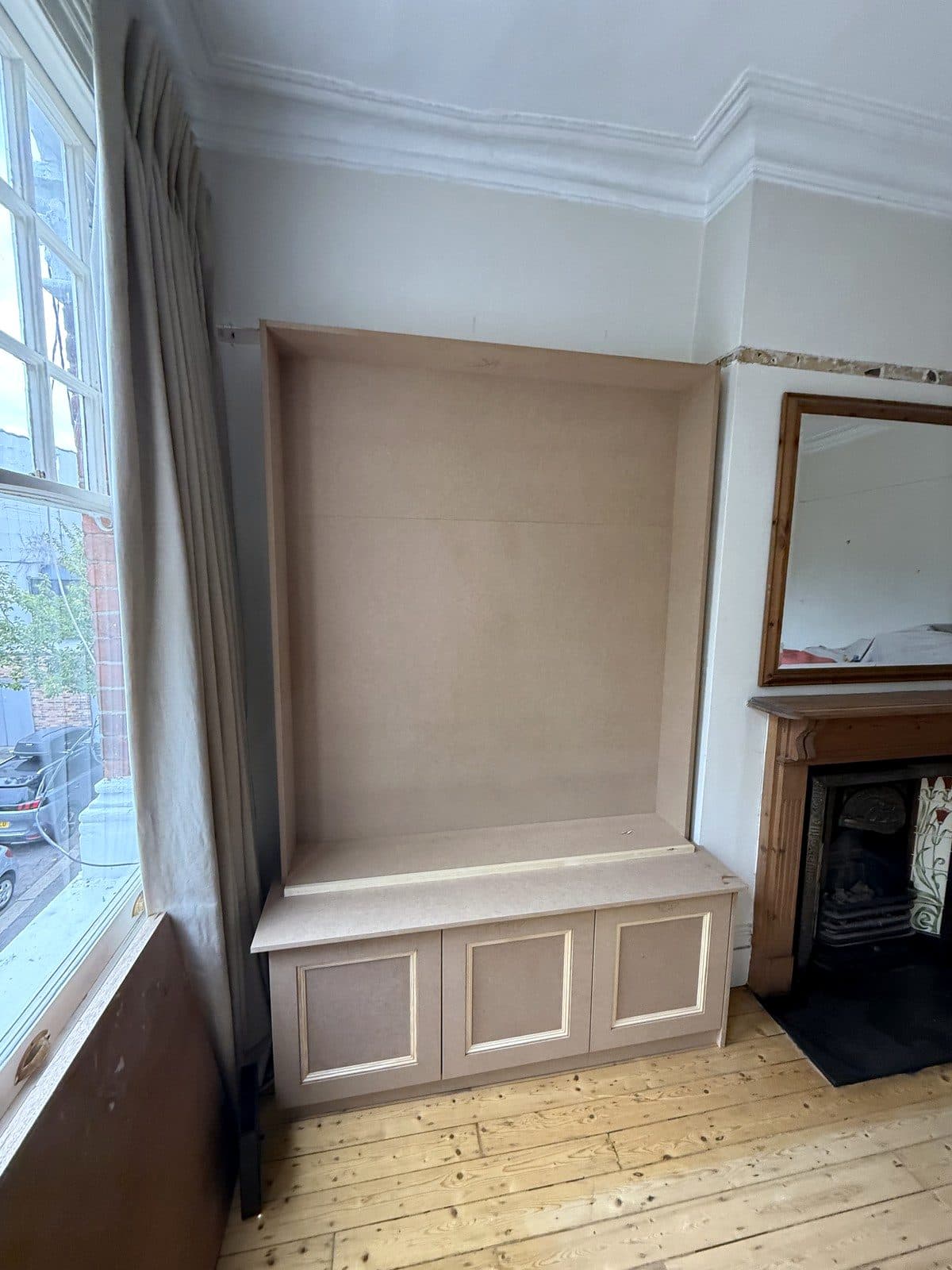 Base cupboard with panelled doors and an MDF back panel lining the alcove