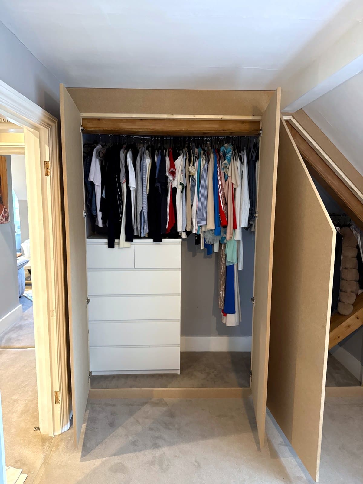 Wardrobe doors open showing the timber post and brace inside