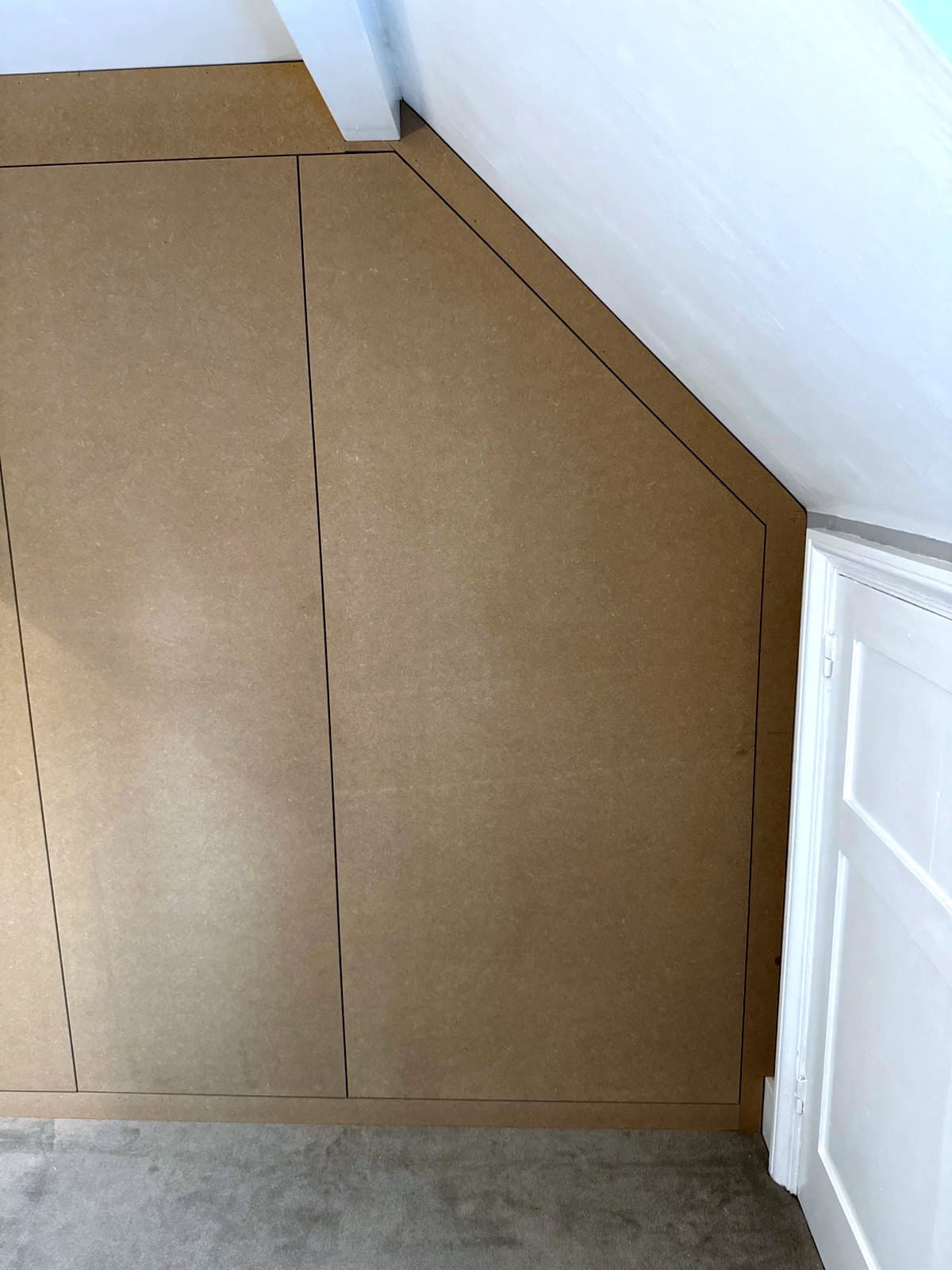 The sloped door closed flush beside the pair